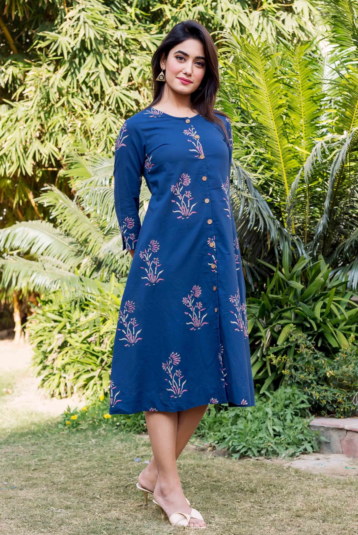 Full-length indigo knee-length dress featuring pink floral block print on a model.