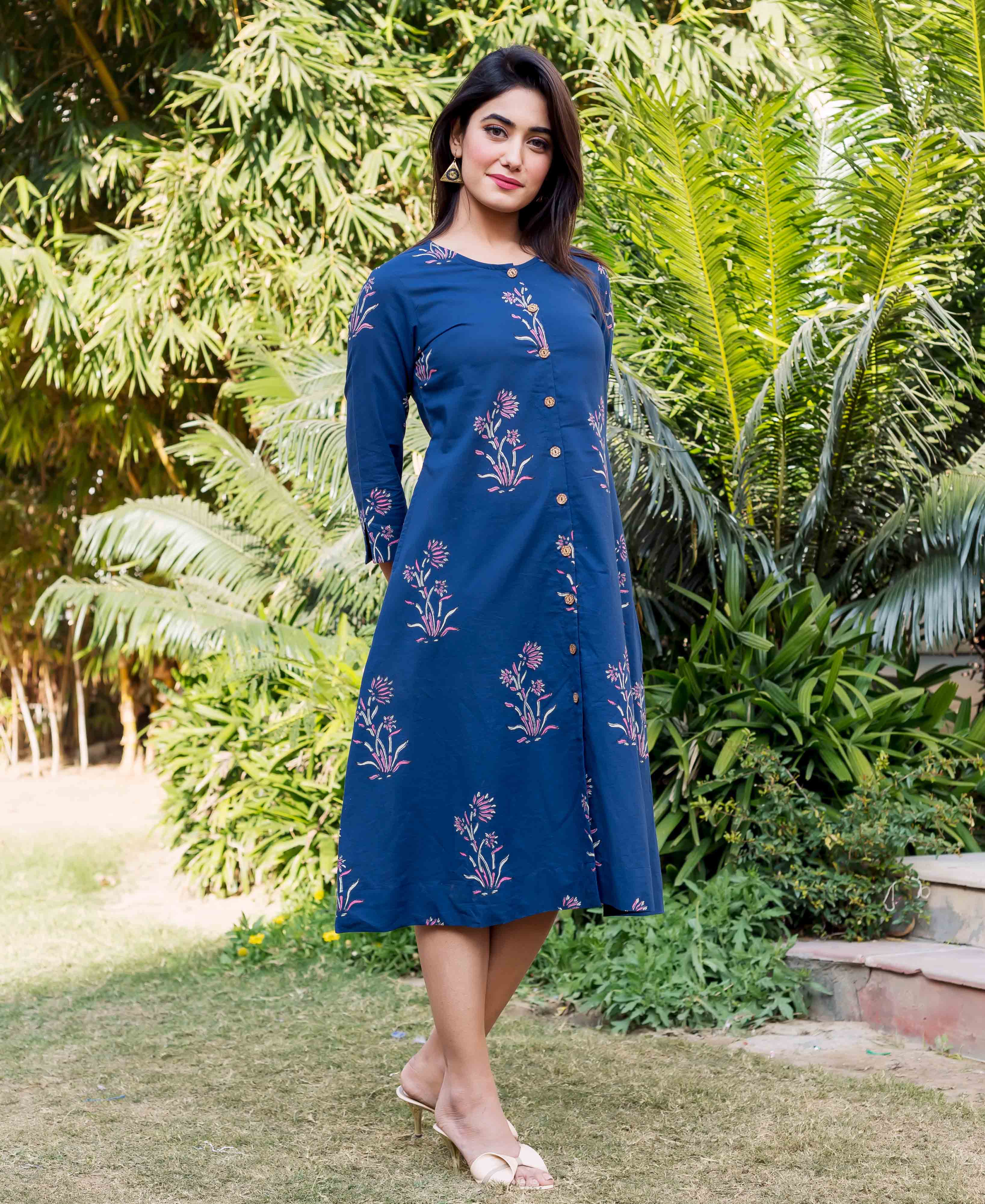 Full-length indigo knee-length dress featuring pink floral block print on a model.