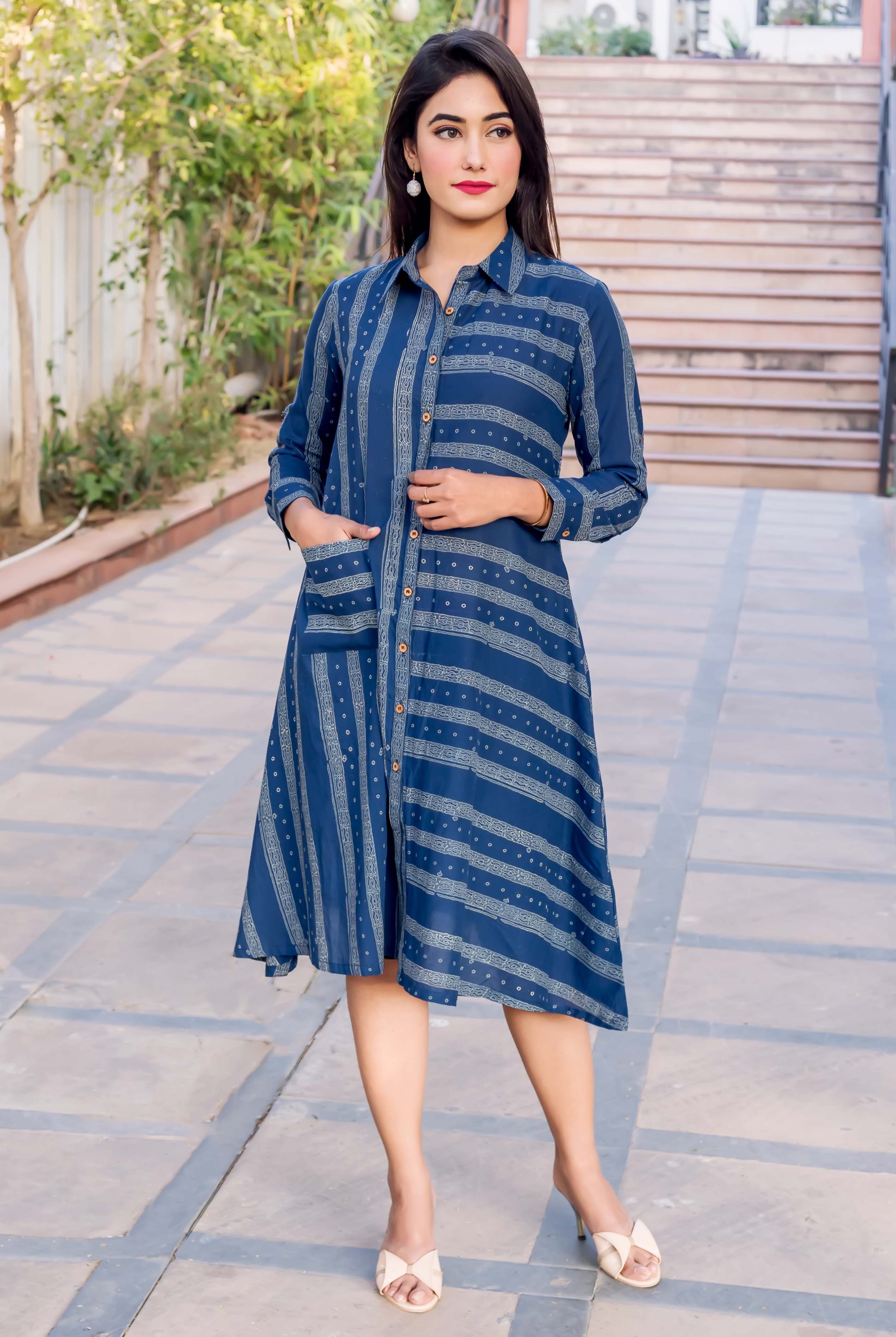 Model full-length: indigo block-printed button-down dress with stripe pattern and pockets.