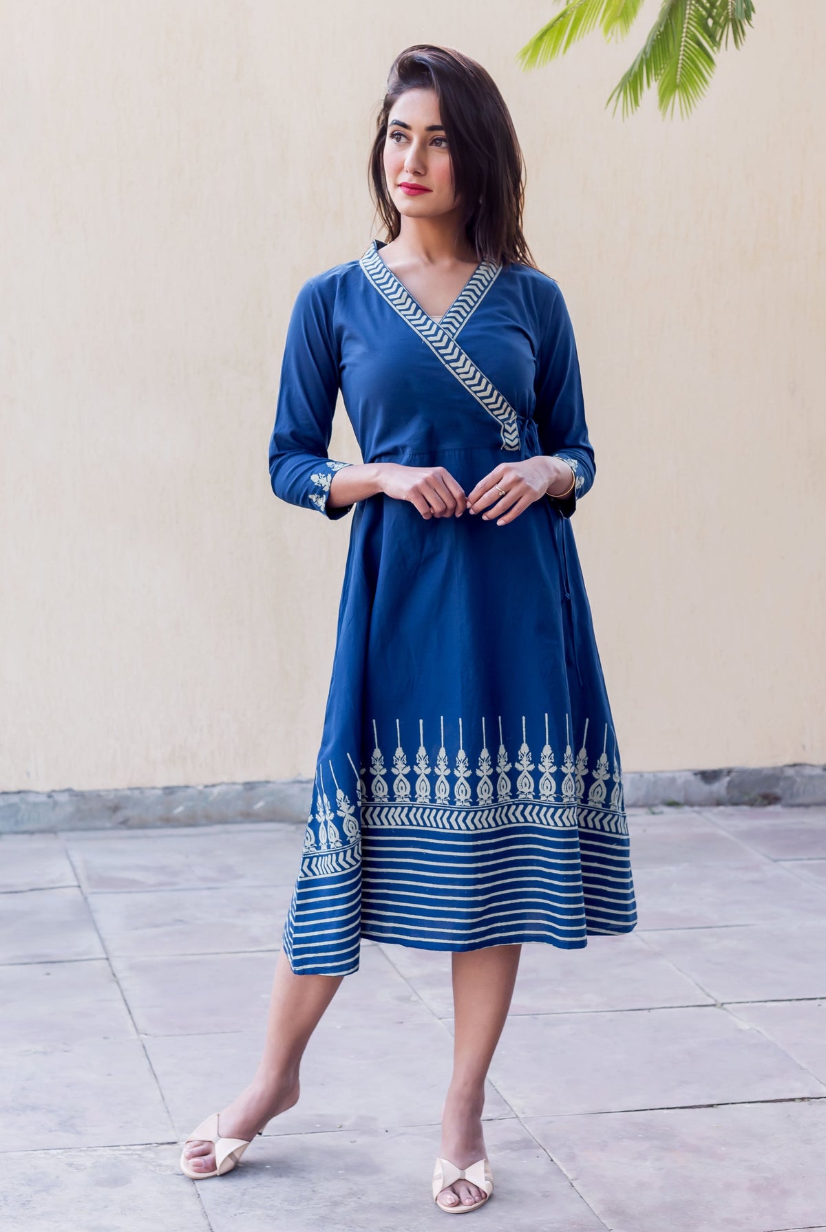 Full look of a model in an indigo angrakha dress with white panel printed patterns.