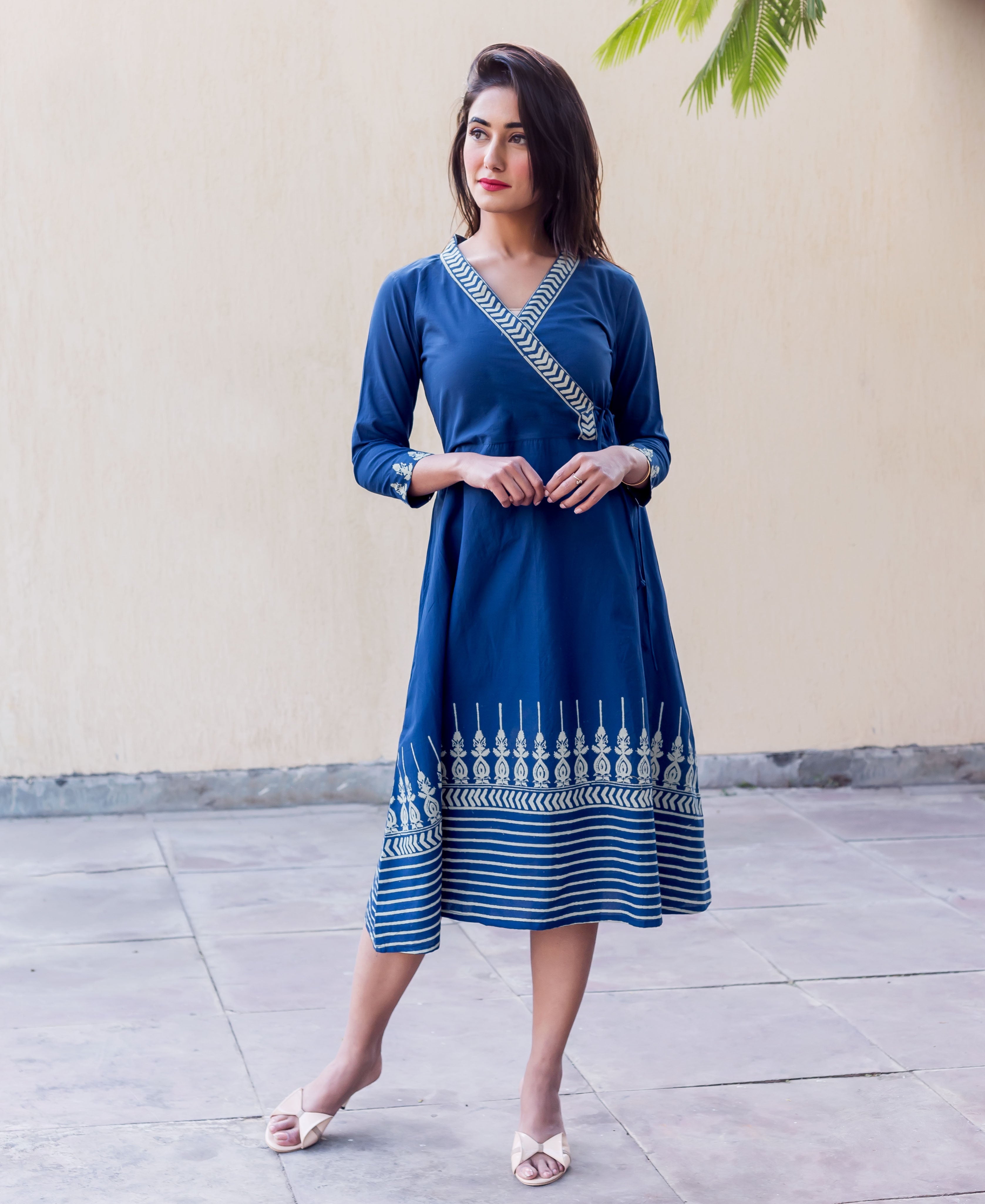Full look of a model in an indigo angrakha dress with white panel printed patterns.