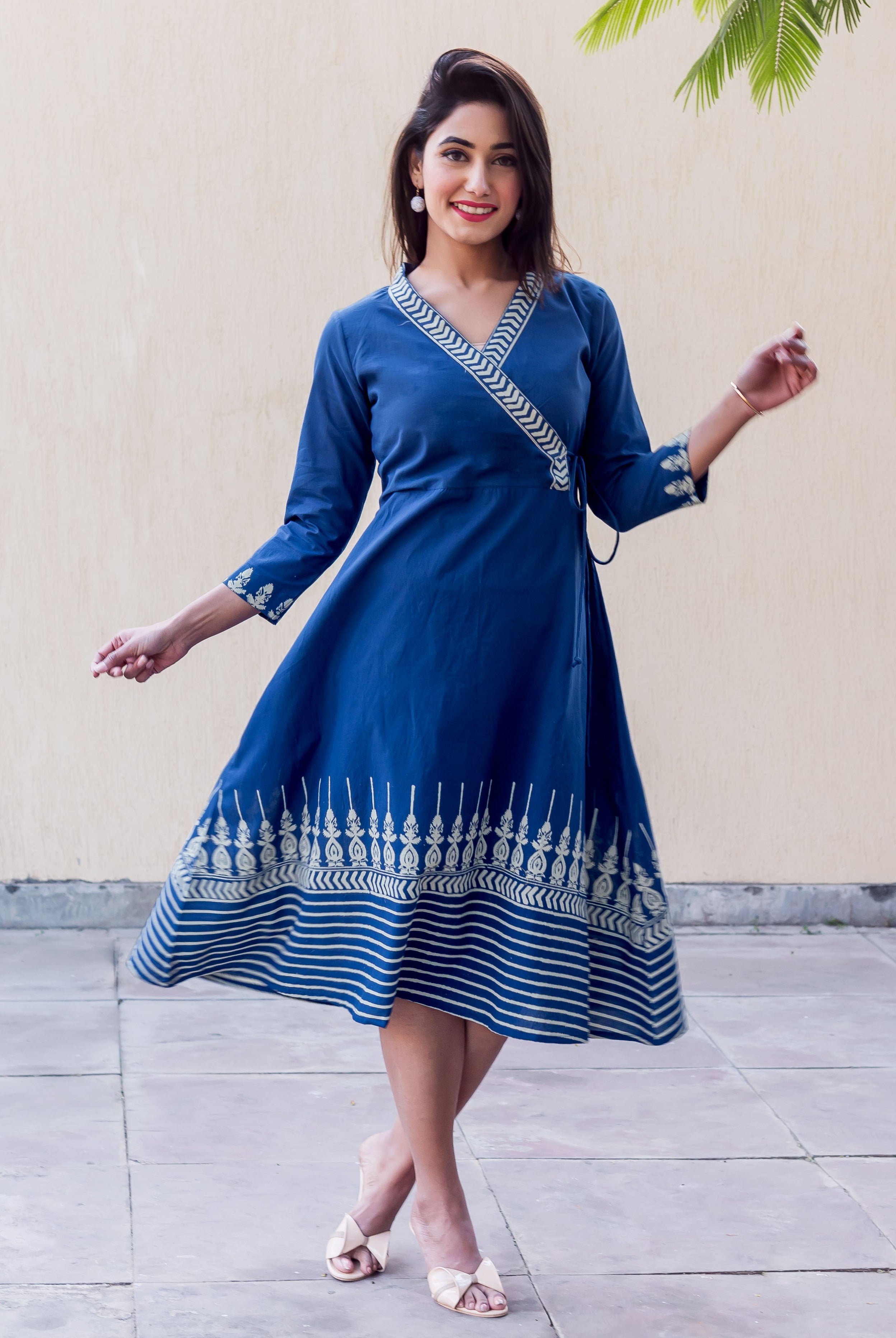 Full look of model in indigo Angrakha dress, block printed V-neck, sleeves, and flared hem.