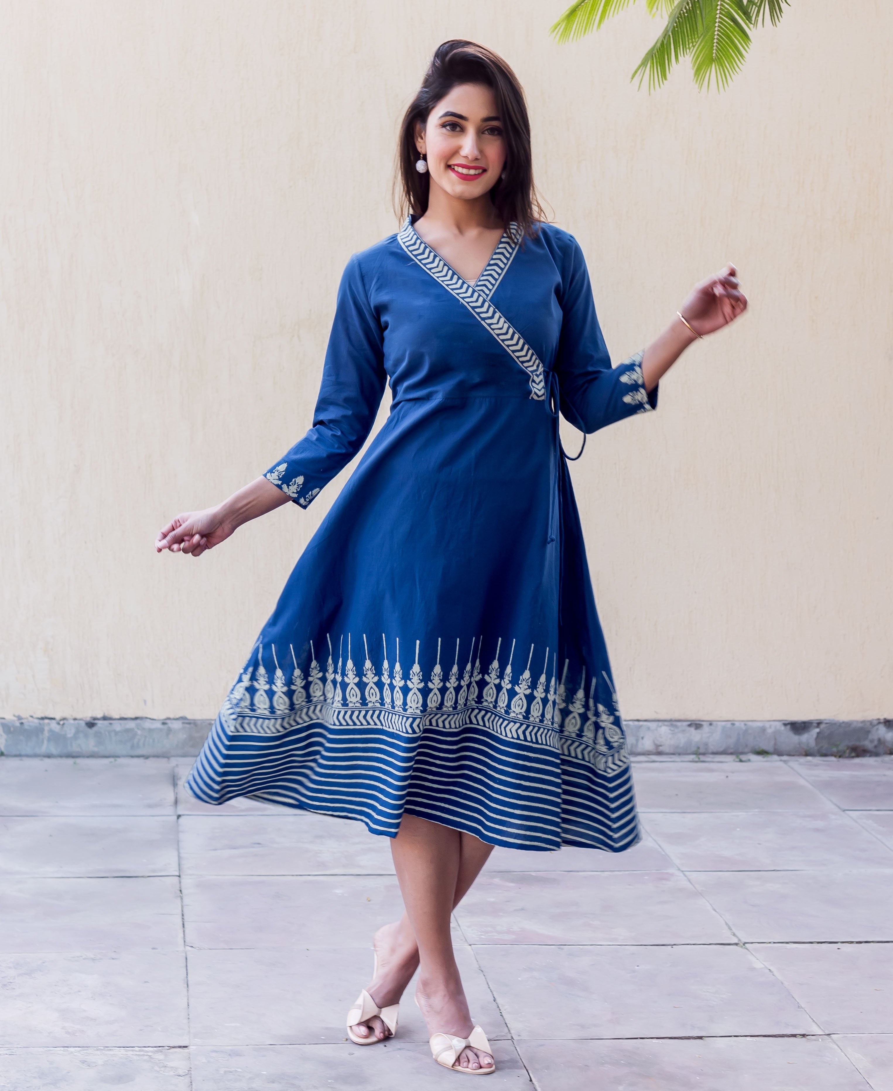 Full look of model in indigo Angrakha dress, block printed V-neck, sleeves, and flared hem.