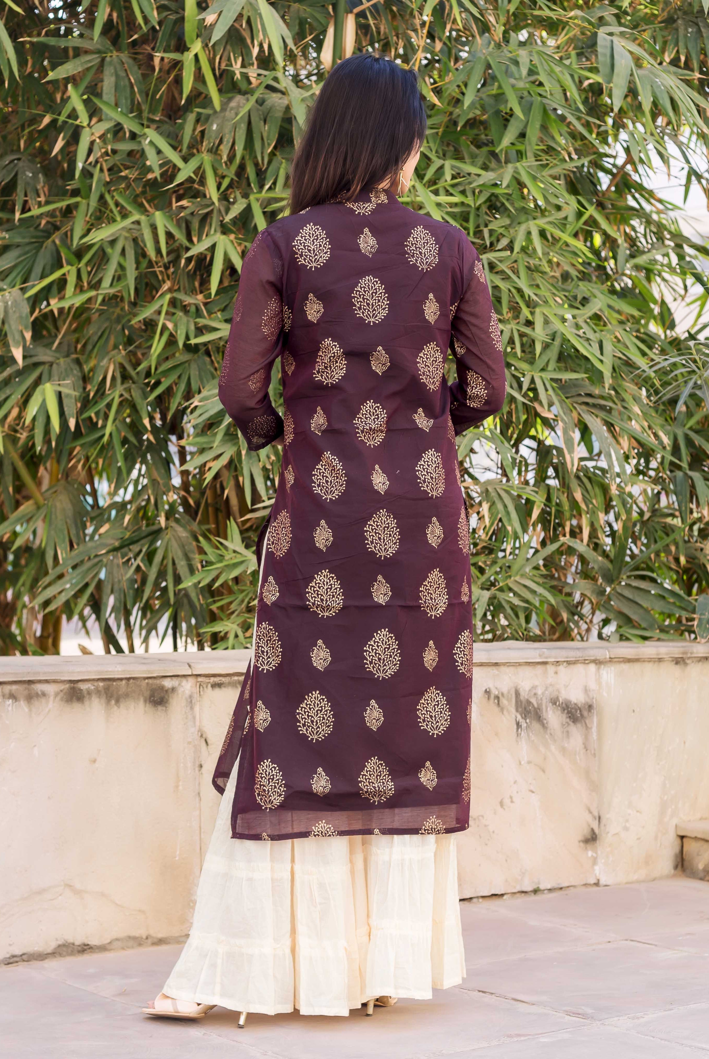 Back view of a model wearing a wine kurta with gold print and cream sharara.