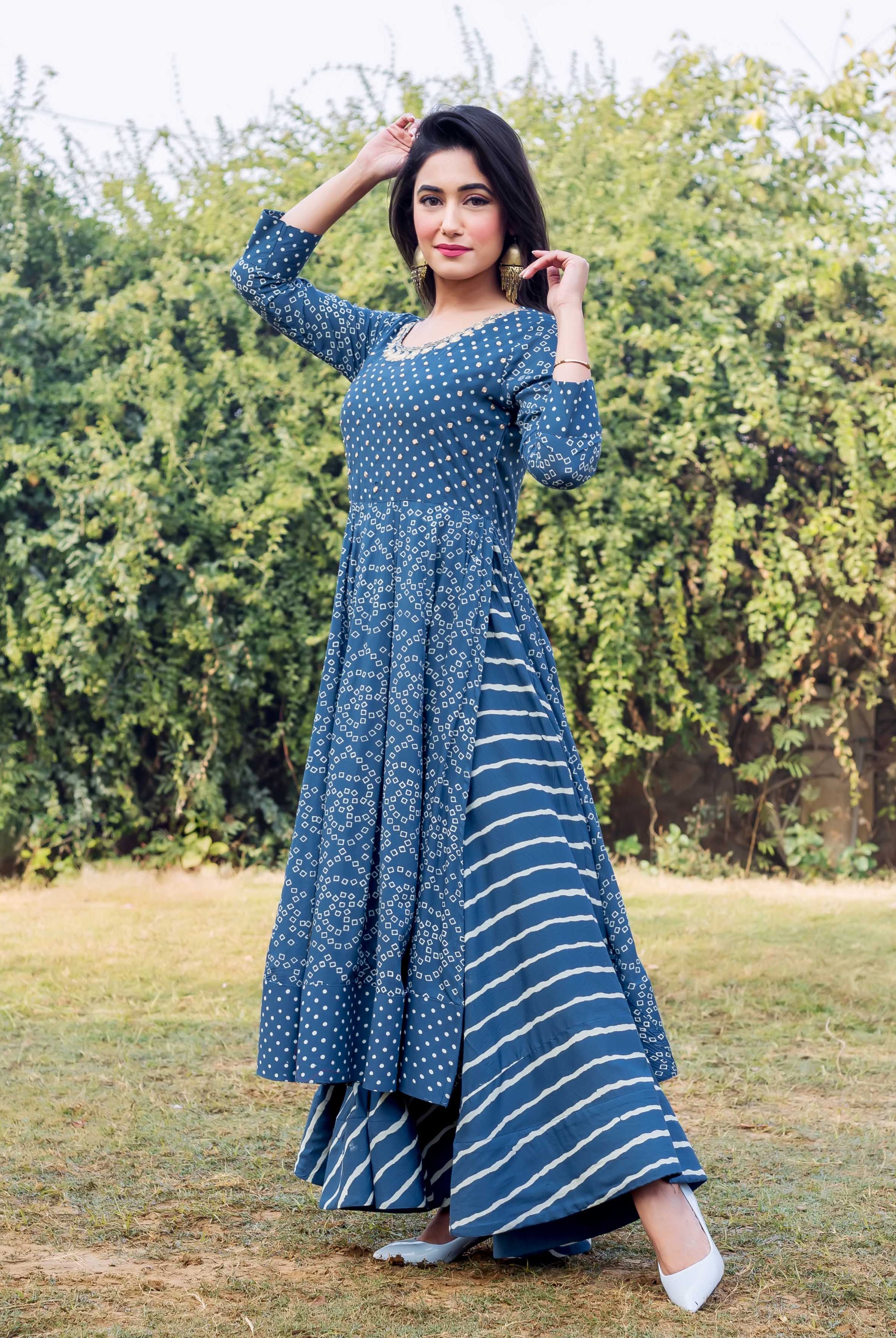 Front view of model in indigo and white printed embroidered layered dress.