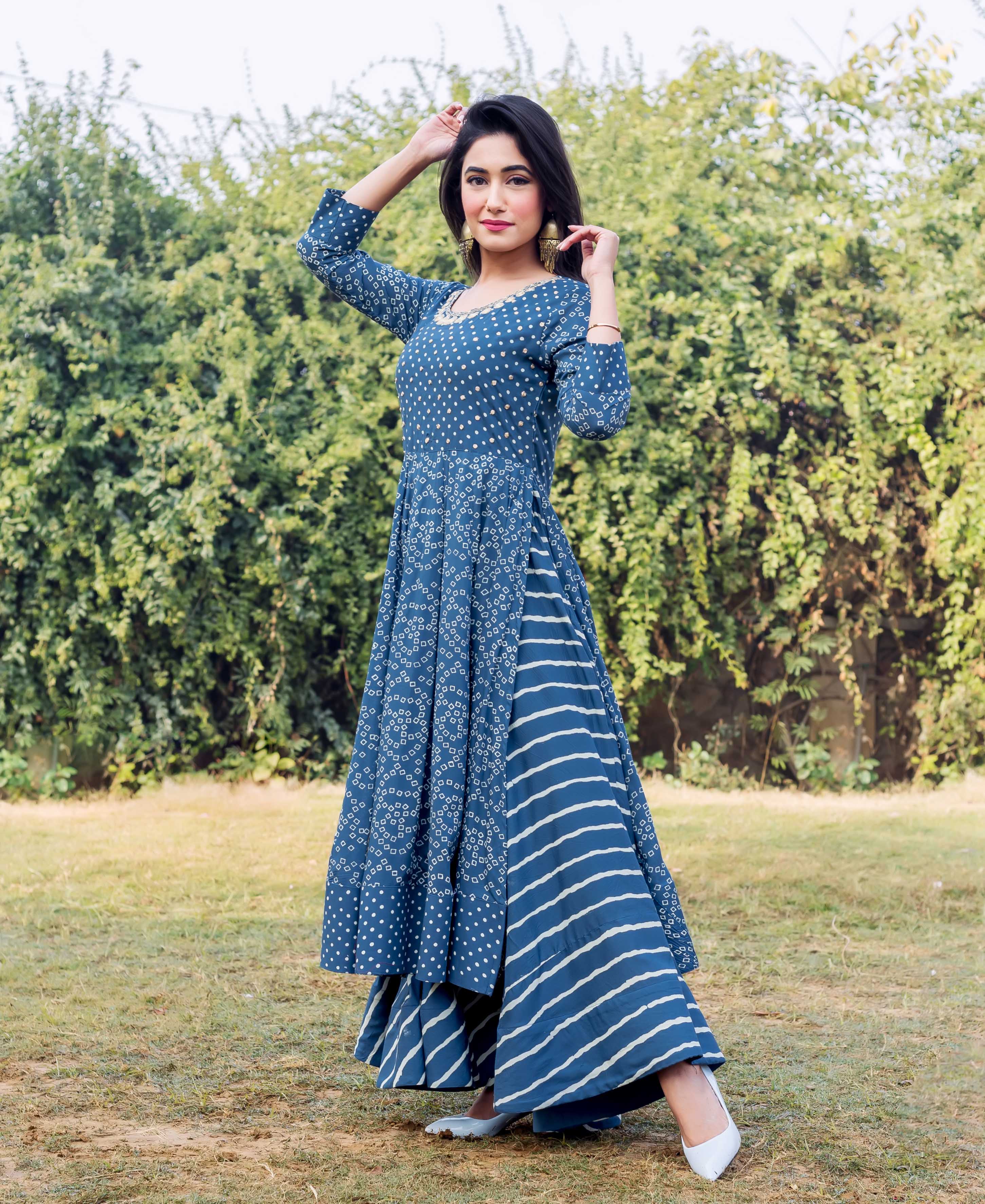 Front view of model in indigo and white printed embroidered layered dress.