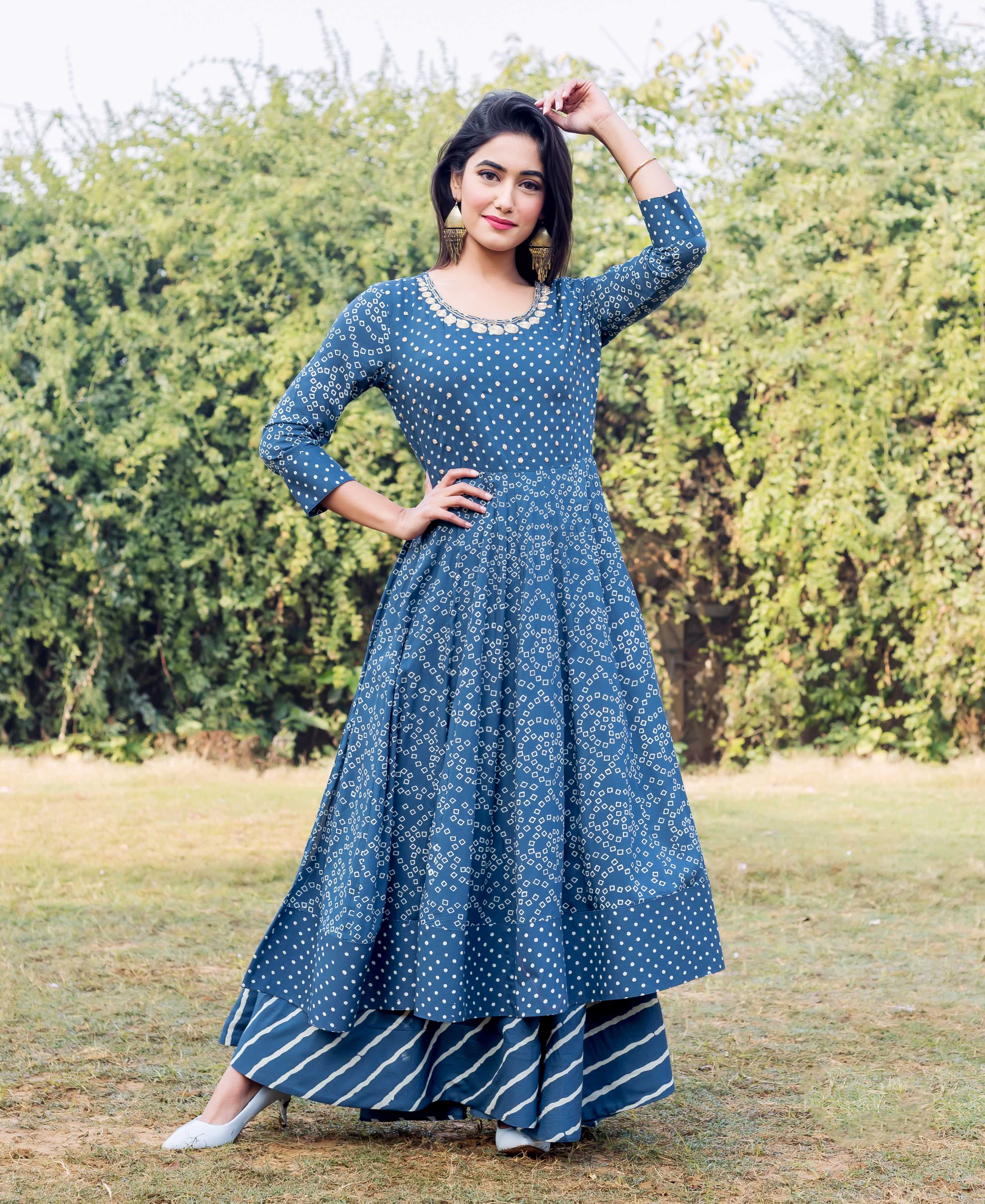 Front full-look of model in an indigo and white printed layered dress with embroidered neckline.