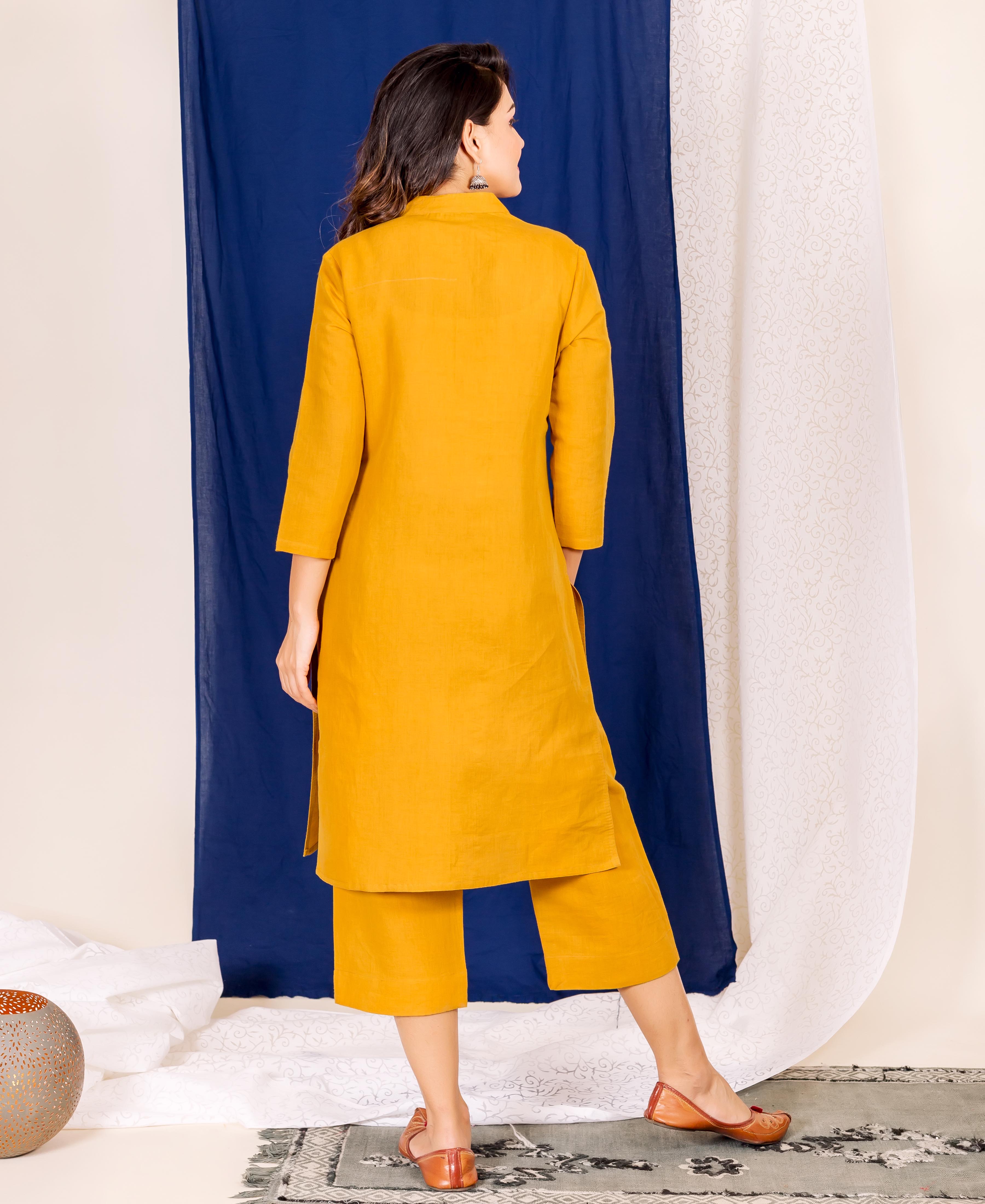 A model wearing a mustard linen kurta with a hand-block print design.