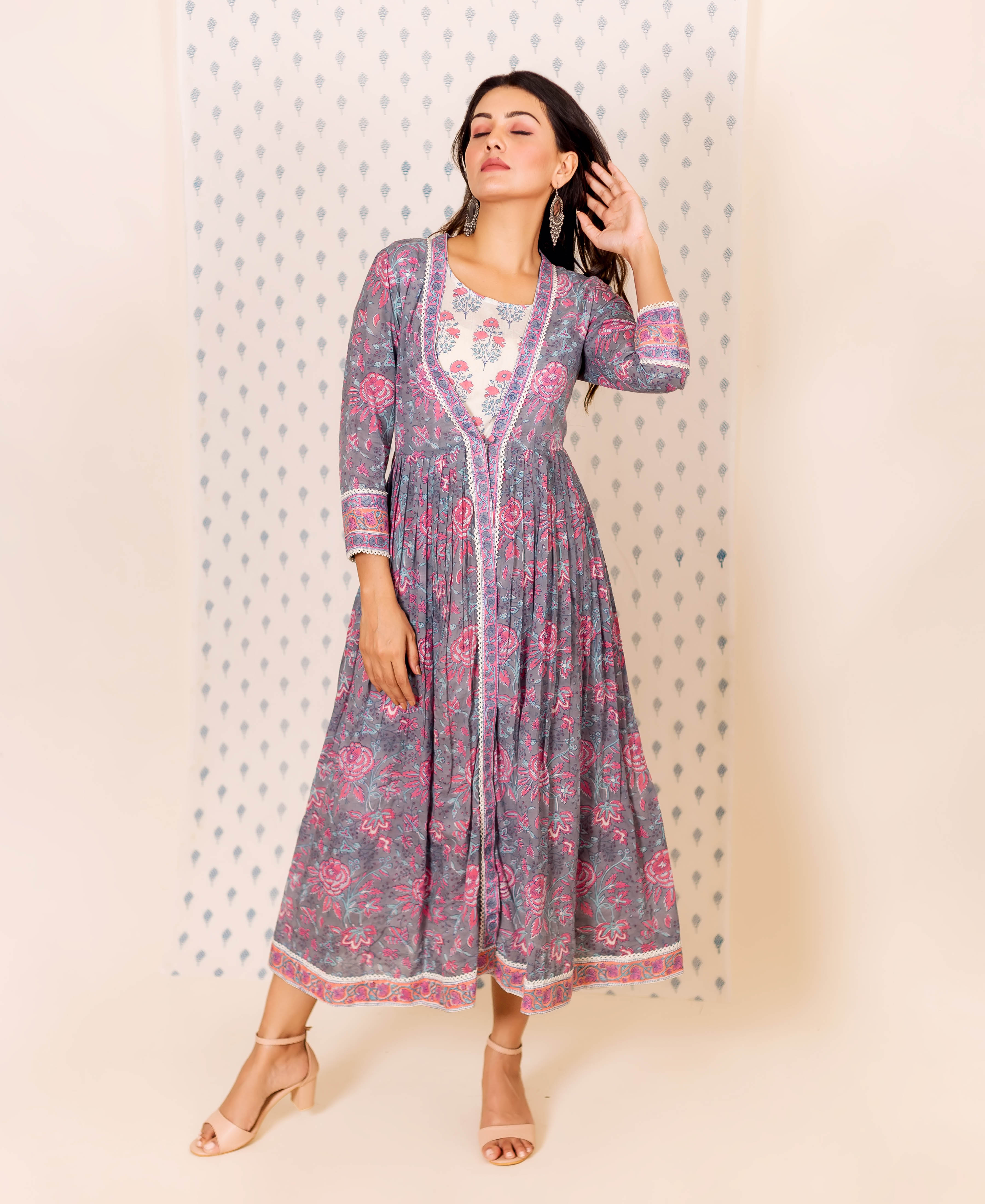 Front view of model wearing grey and pink misprint hand block printed dress with inner.