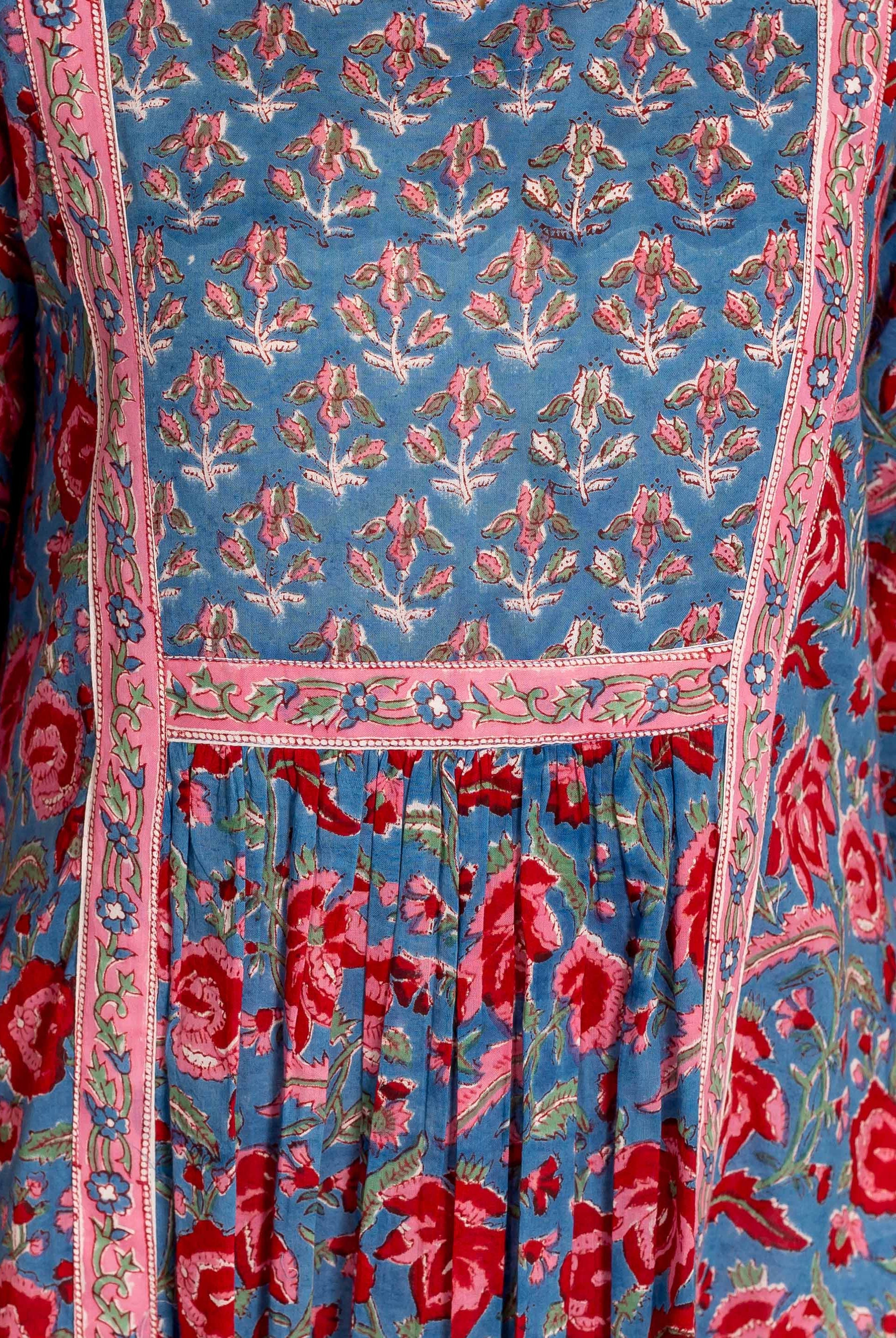 Close-up of blue and red hand block printed kurta, featuring varied floral patterns and pink trim.