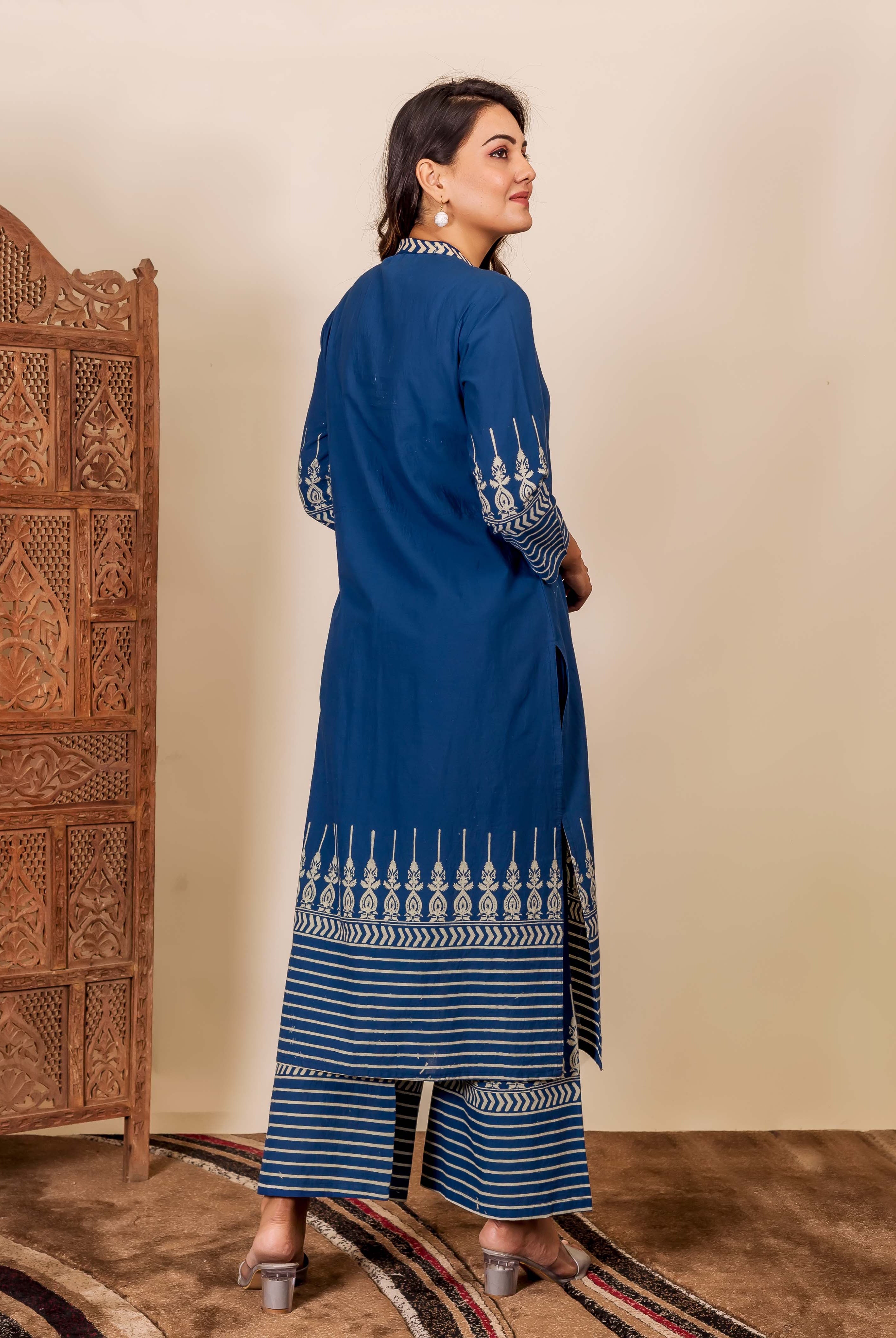 Model from back wearing an indigo hand-block printed kurta set with white ethnic patterns.