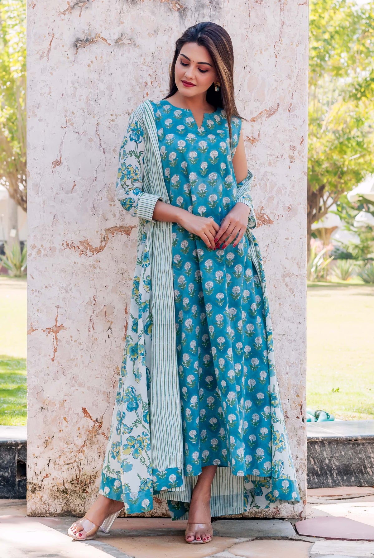 Front full look: model in teal floral hand block print dress with matching jacket.