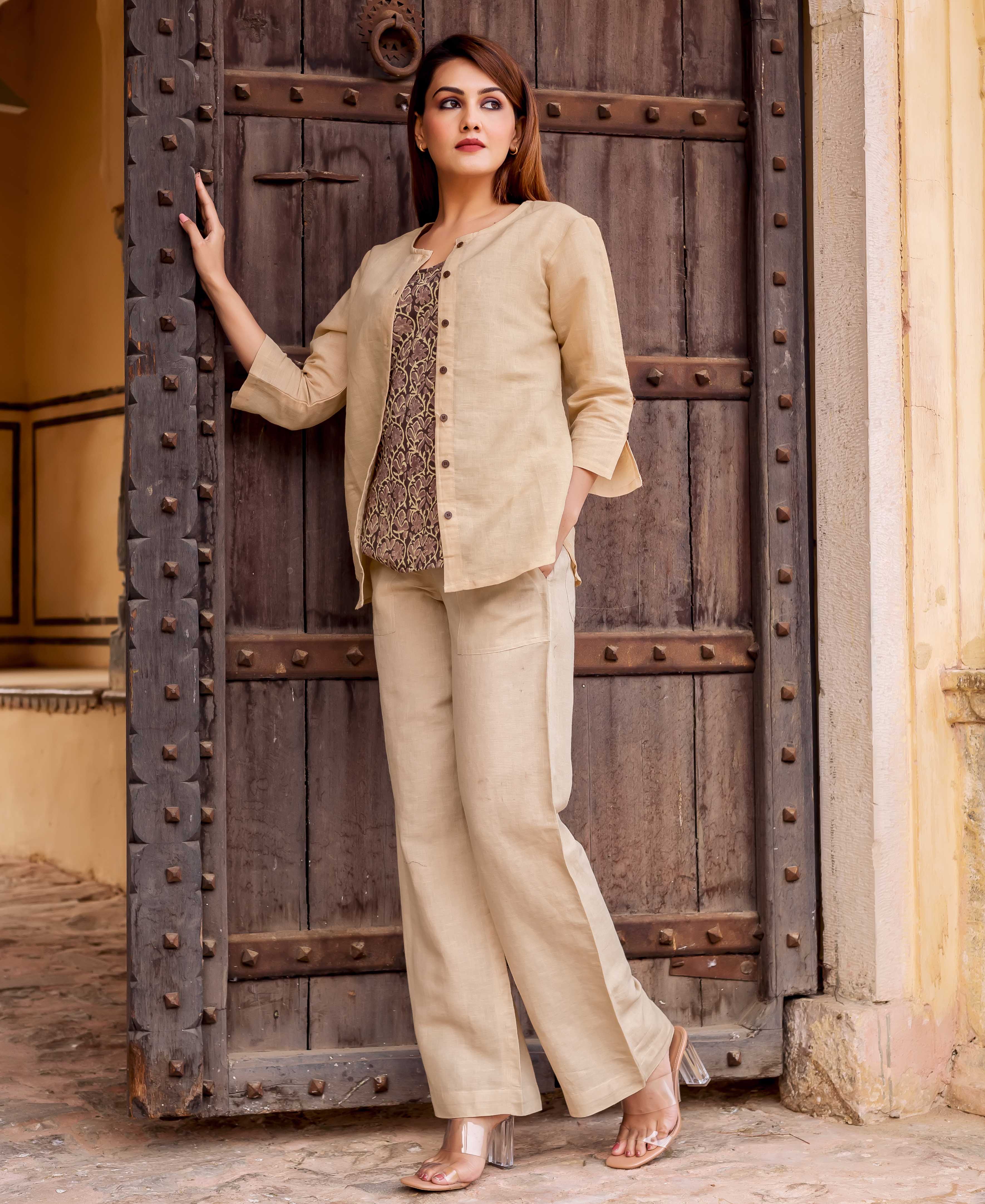Front full look of model in beige linen set with hand-block-printed ethnic inner top.