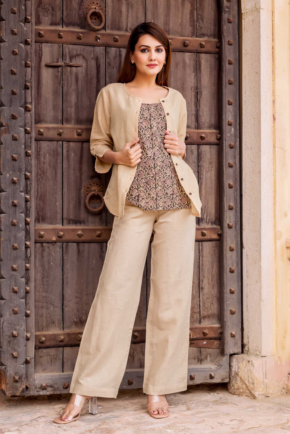 Full-length front view of model in beige linen coordinated set with ethnic print top.