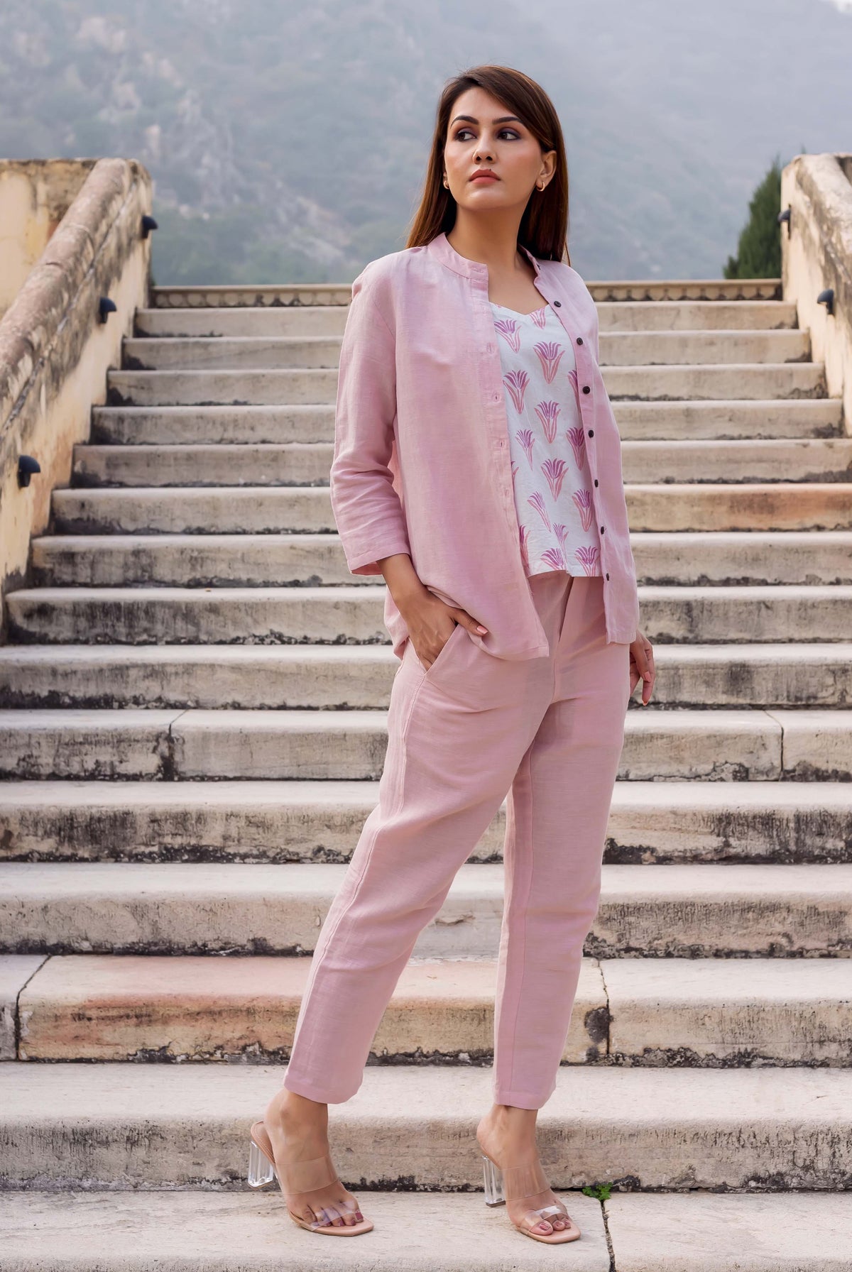 Model wears flamingo pink linen coordinated set, white hand-block-printed ethnic top, front view.