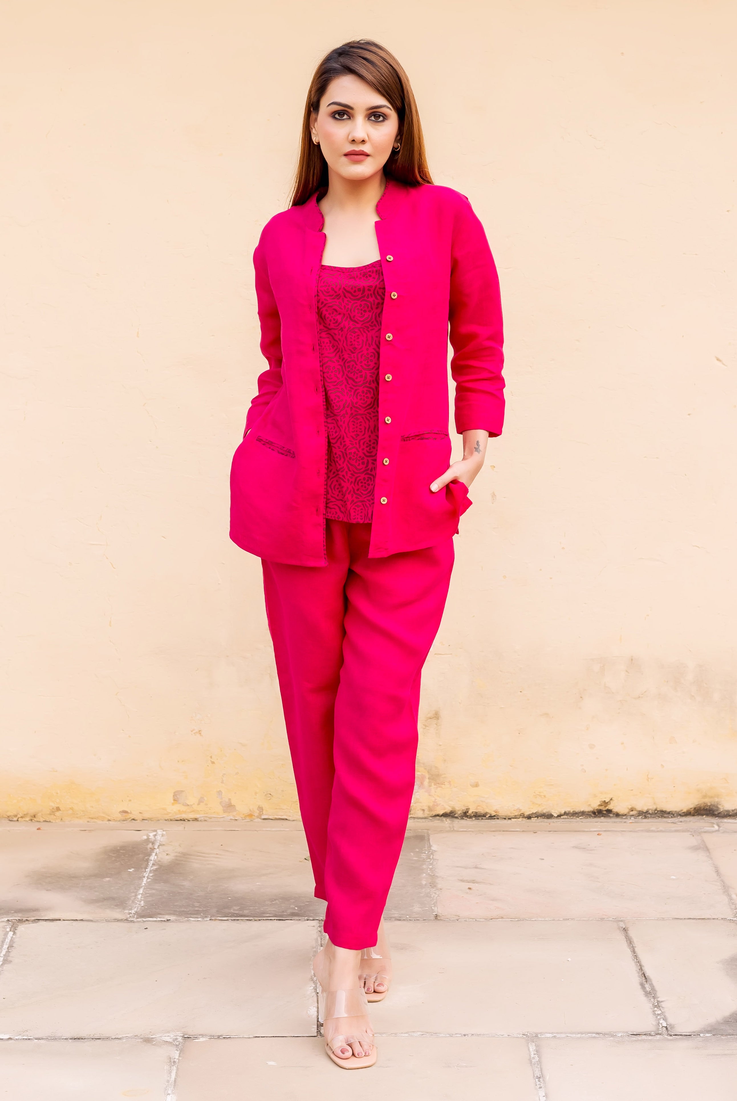 Full-length model in ruby pink linen suit with a hand-block-printed ethnic inner top.