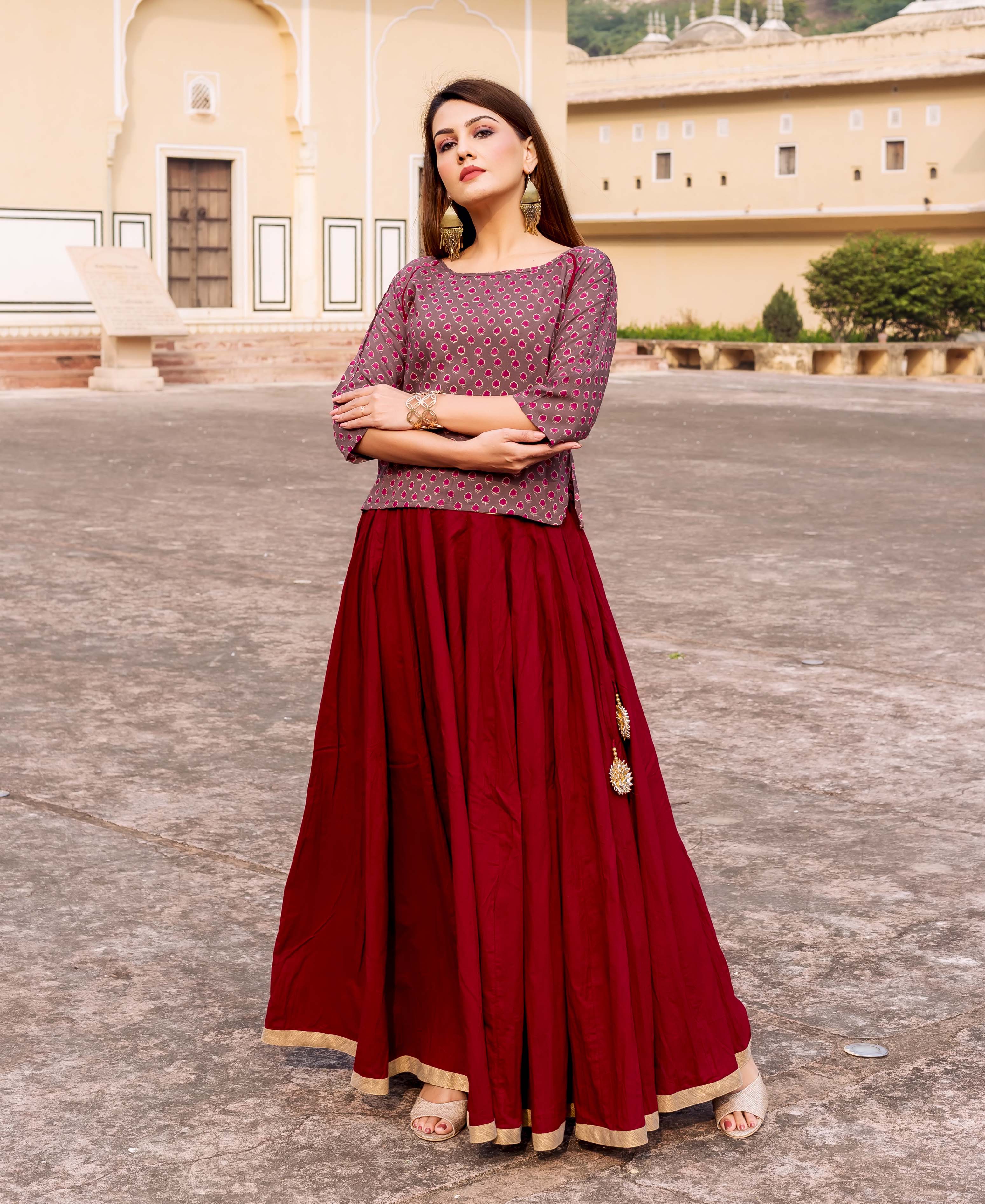 Standing model wearing maroon and brown ethnic hand-block-printed short top.