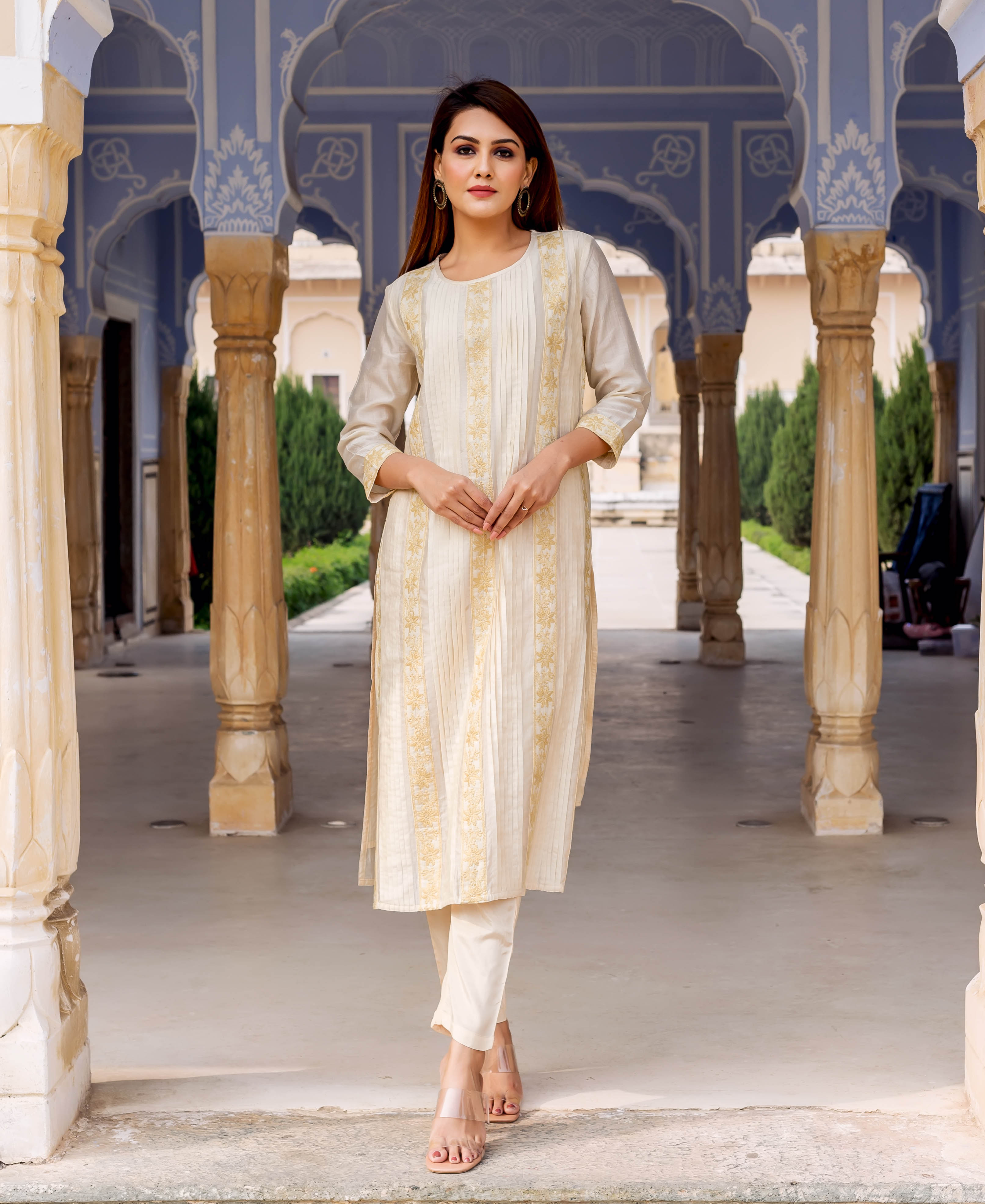 Female model in an off-white embroidered and hand-block printed straight kurta set.