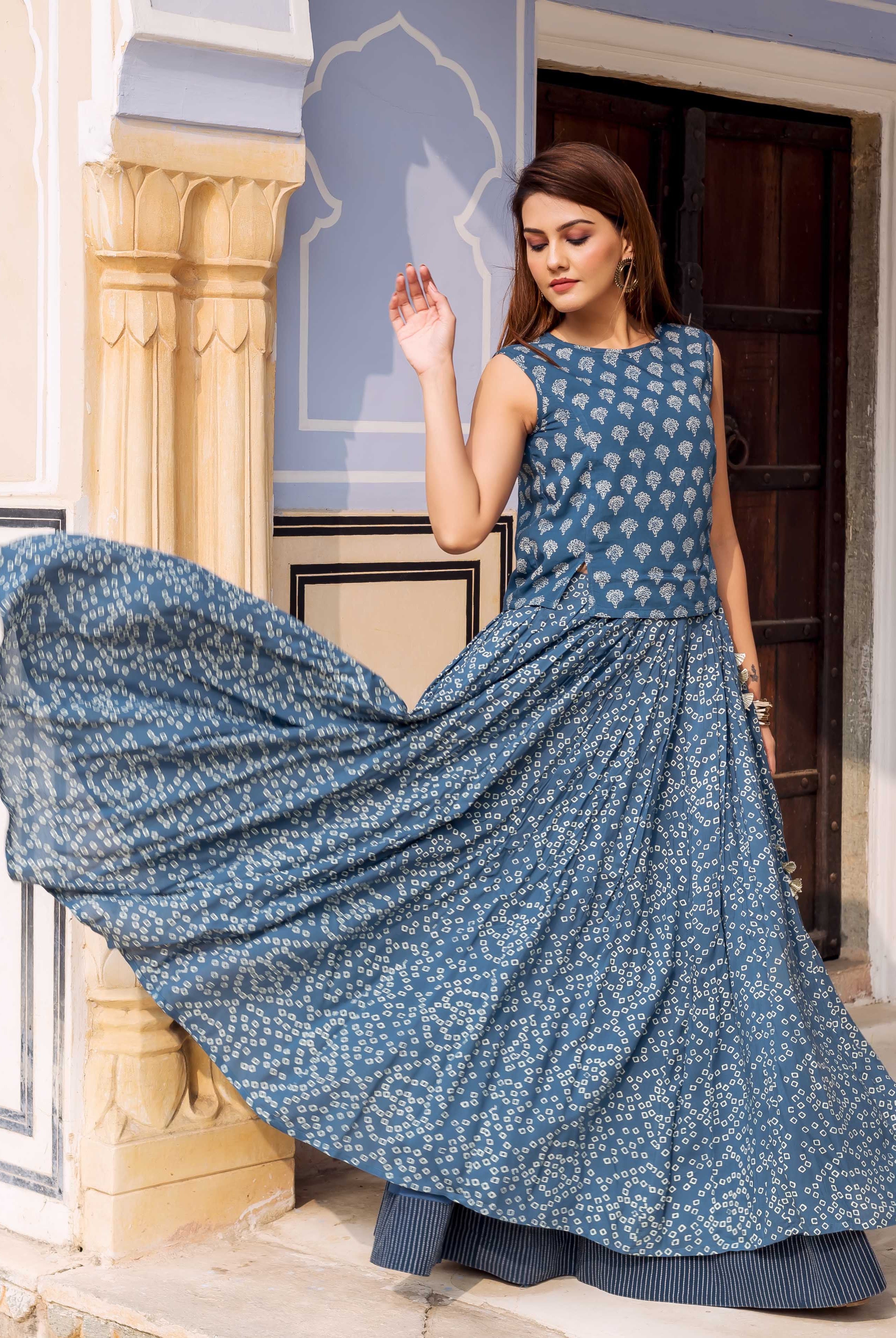 Female model posing in an indigo hand-block-printed sleeveless top and matching maxi skirt.