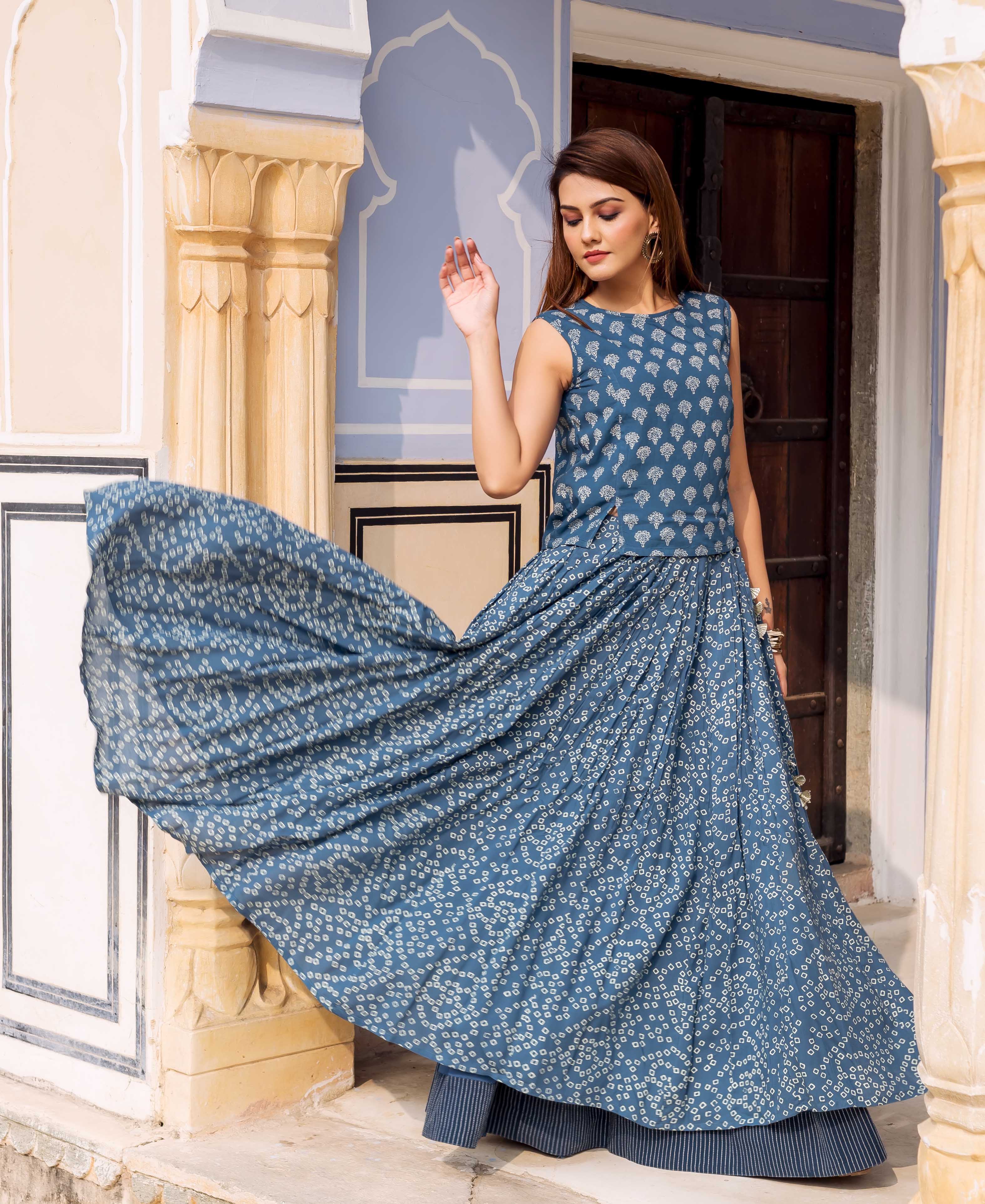 Female model posing in an indigo hand-block-printed sleeveless top and matching maxi skirt.