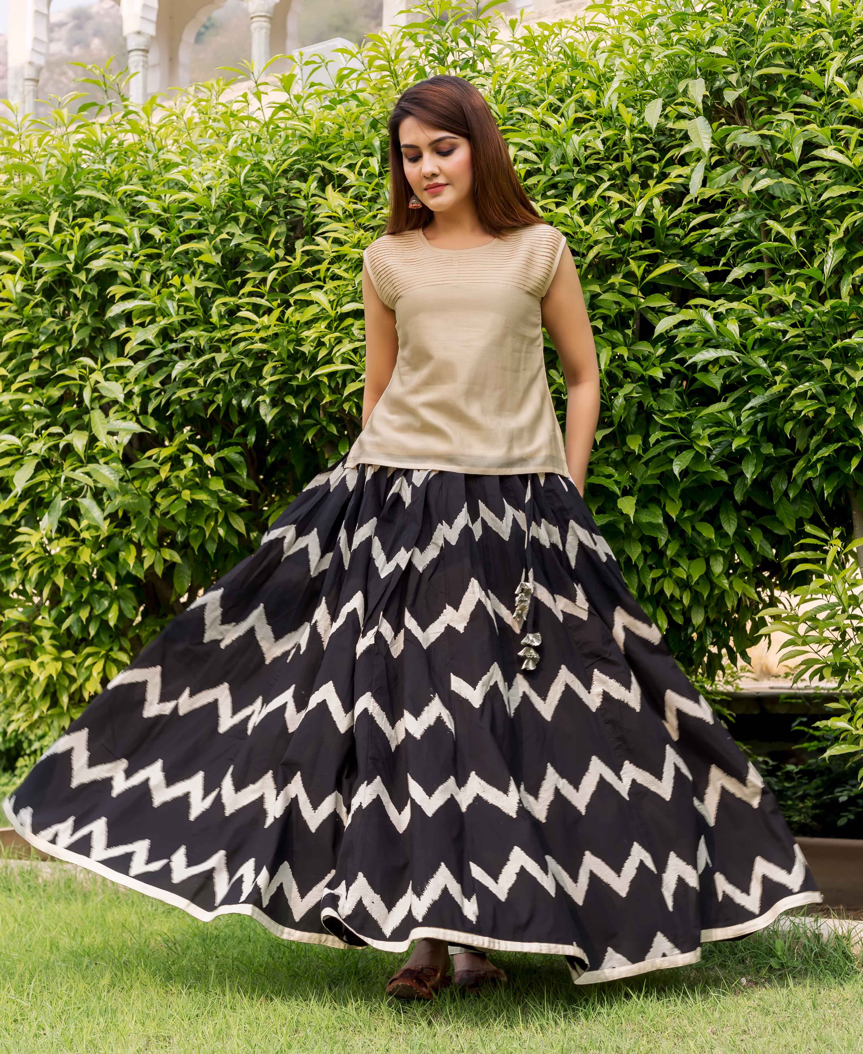 Model in beige chanderi sleeveless top and black-and-white chevron print skirt.