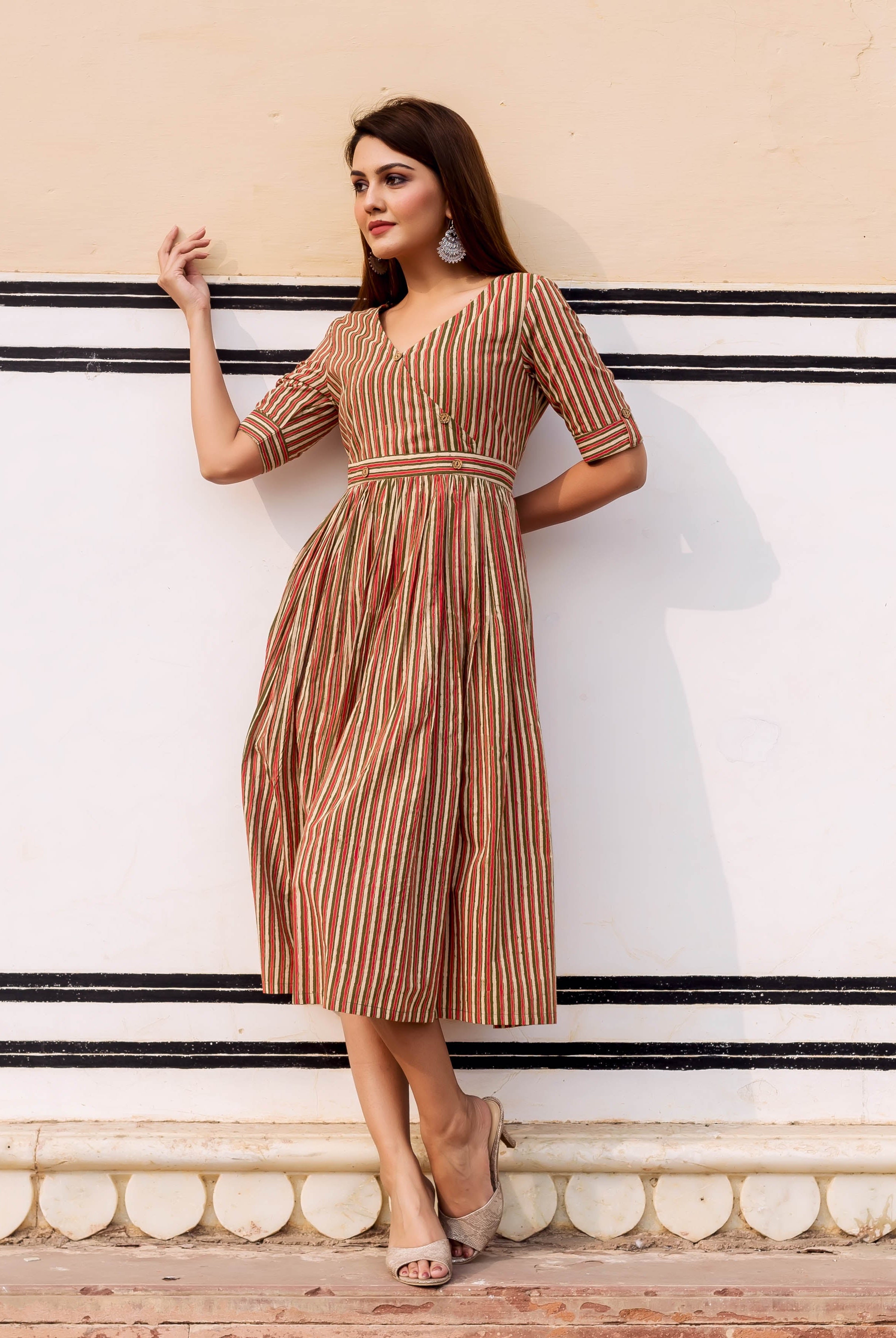 Model in olive, red, and cream striped hand block printed midi sundress.