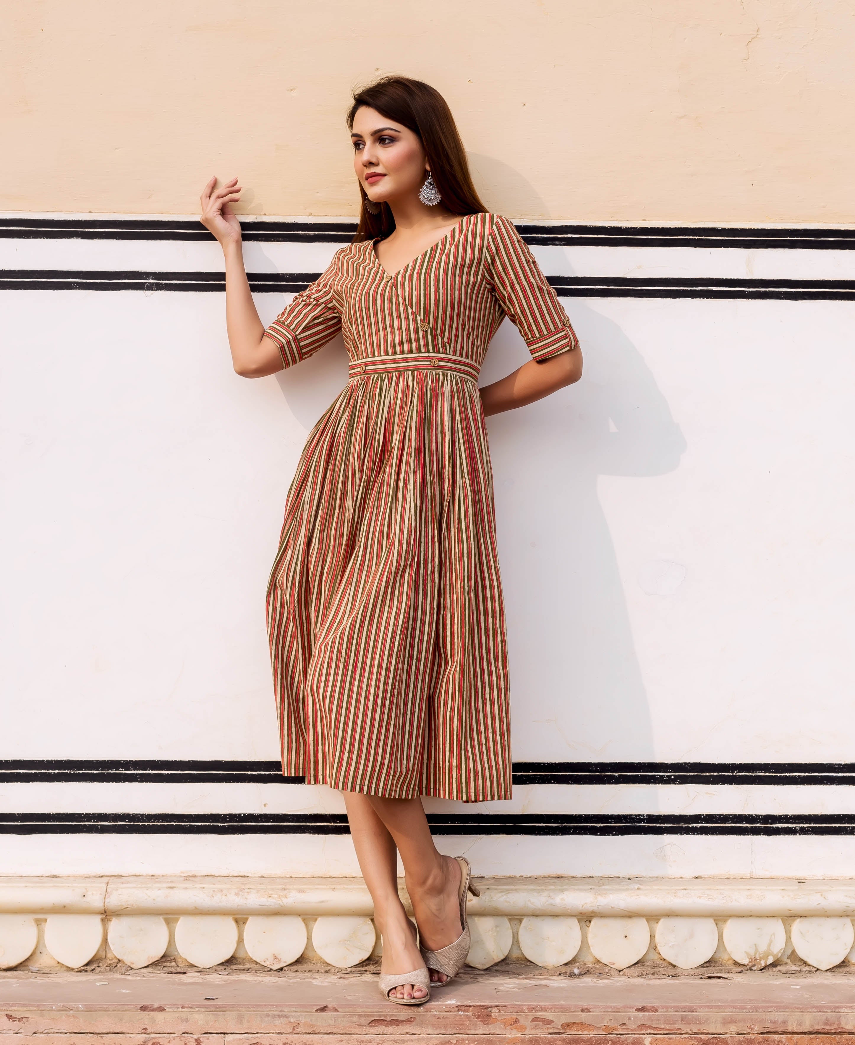 Model in olive, red, and cream striped hand block printed midi sundress.