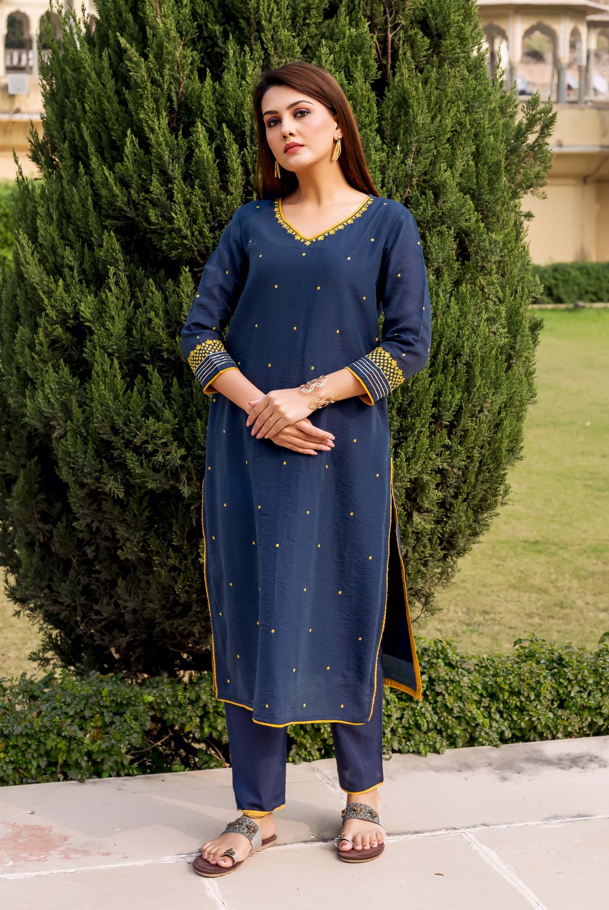 Navy blue kurta with yellow embroidered details and small yellow dots, paired with matching pants.