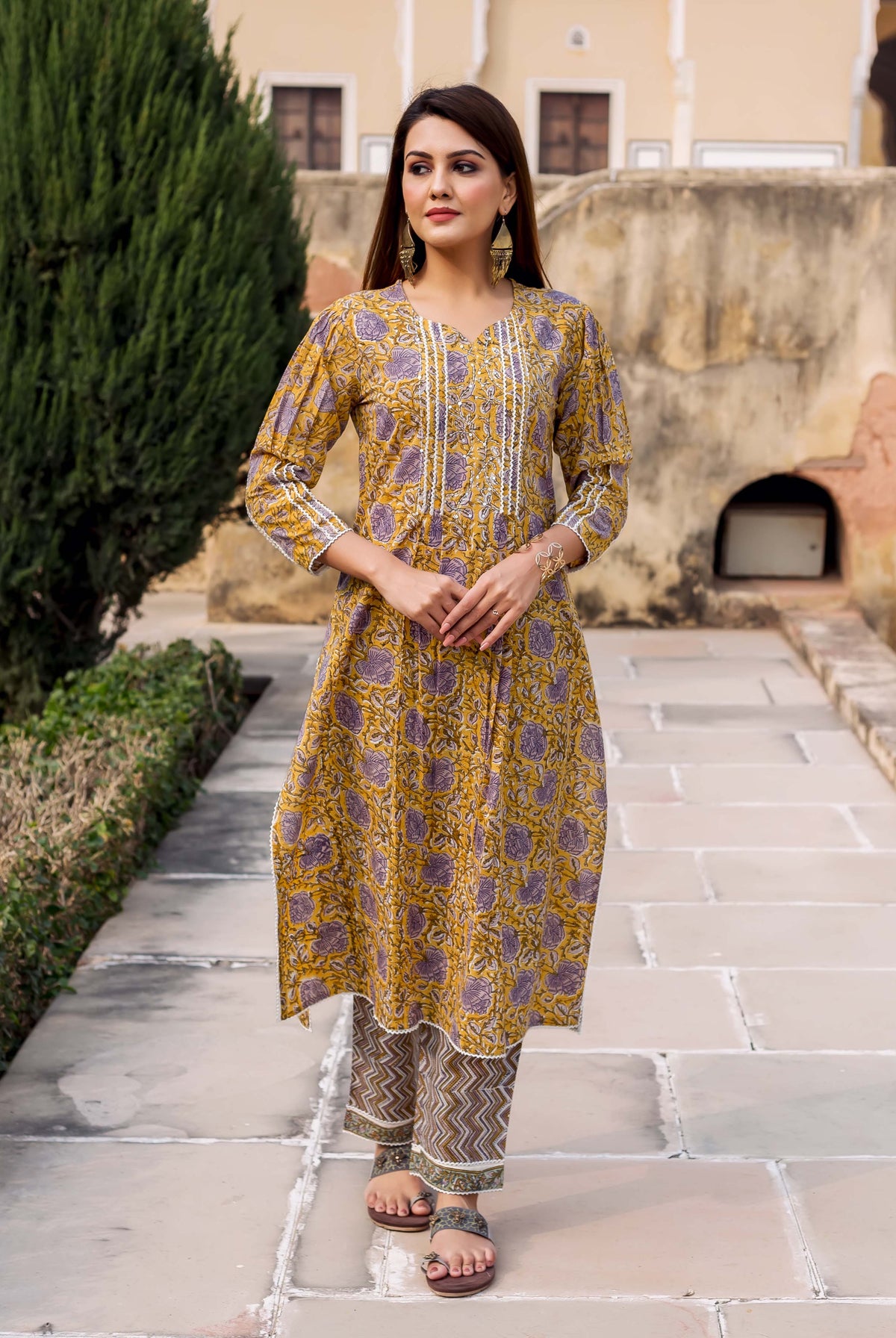 Front view of a model wearing a yellow and grey hand block printed straight kurta set.