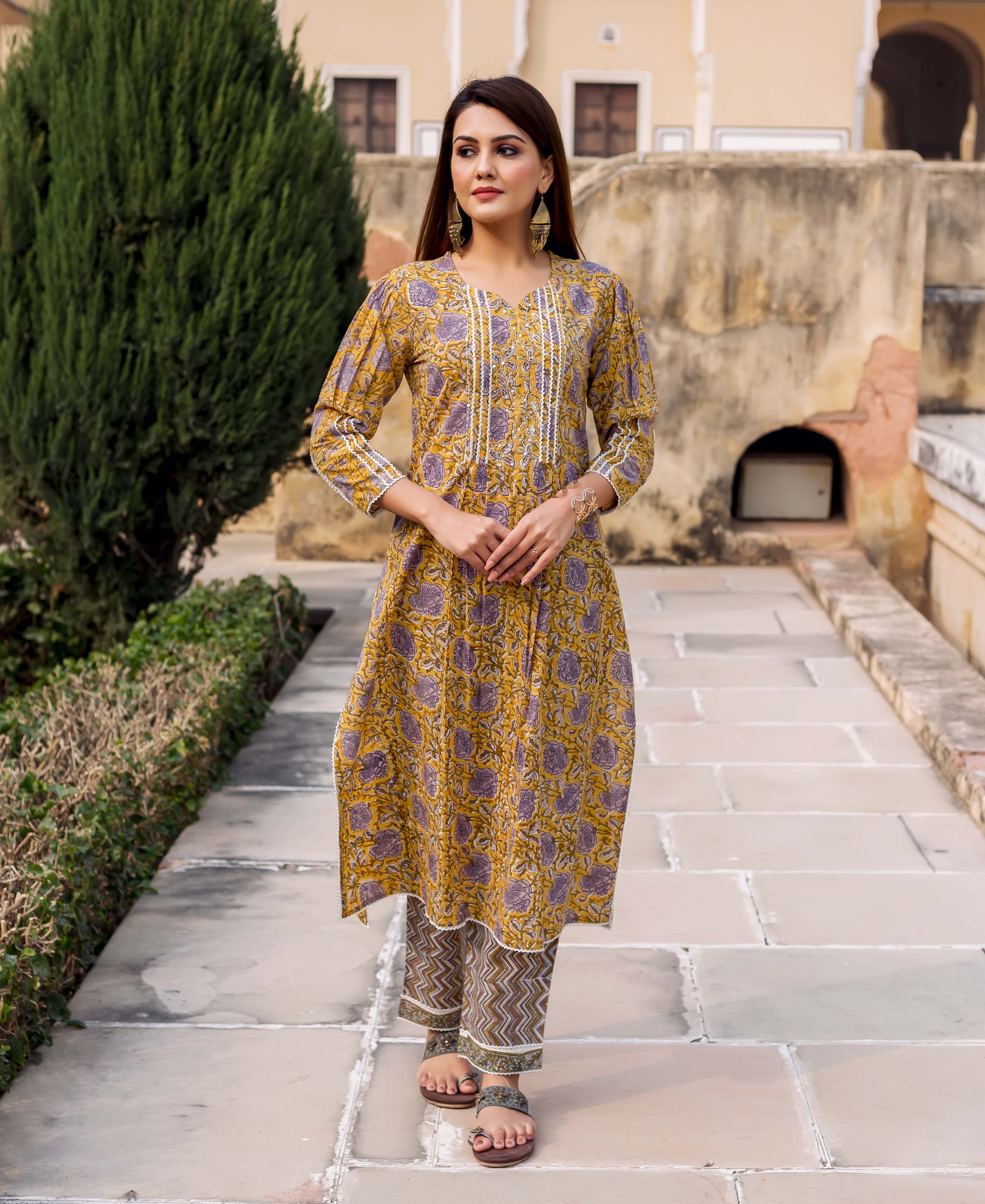 Front view of a model wearing a yellow and grey hand block printed straight kurta set.