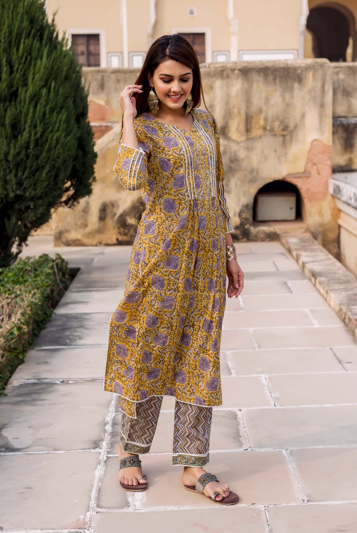 Front full look of Gauravi yellow and grey hand block printed kurta set on a model.