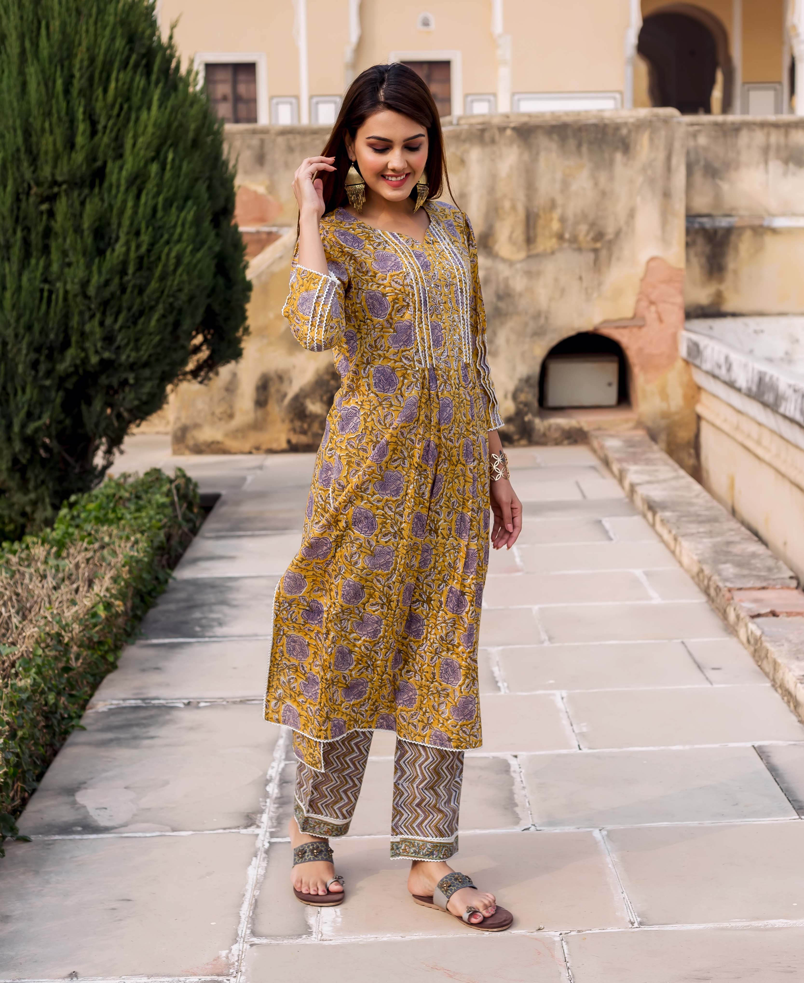 Front full look of Gauravi yellow and grey hand block printed kurta set on a model.