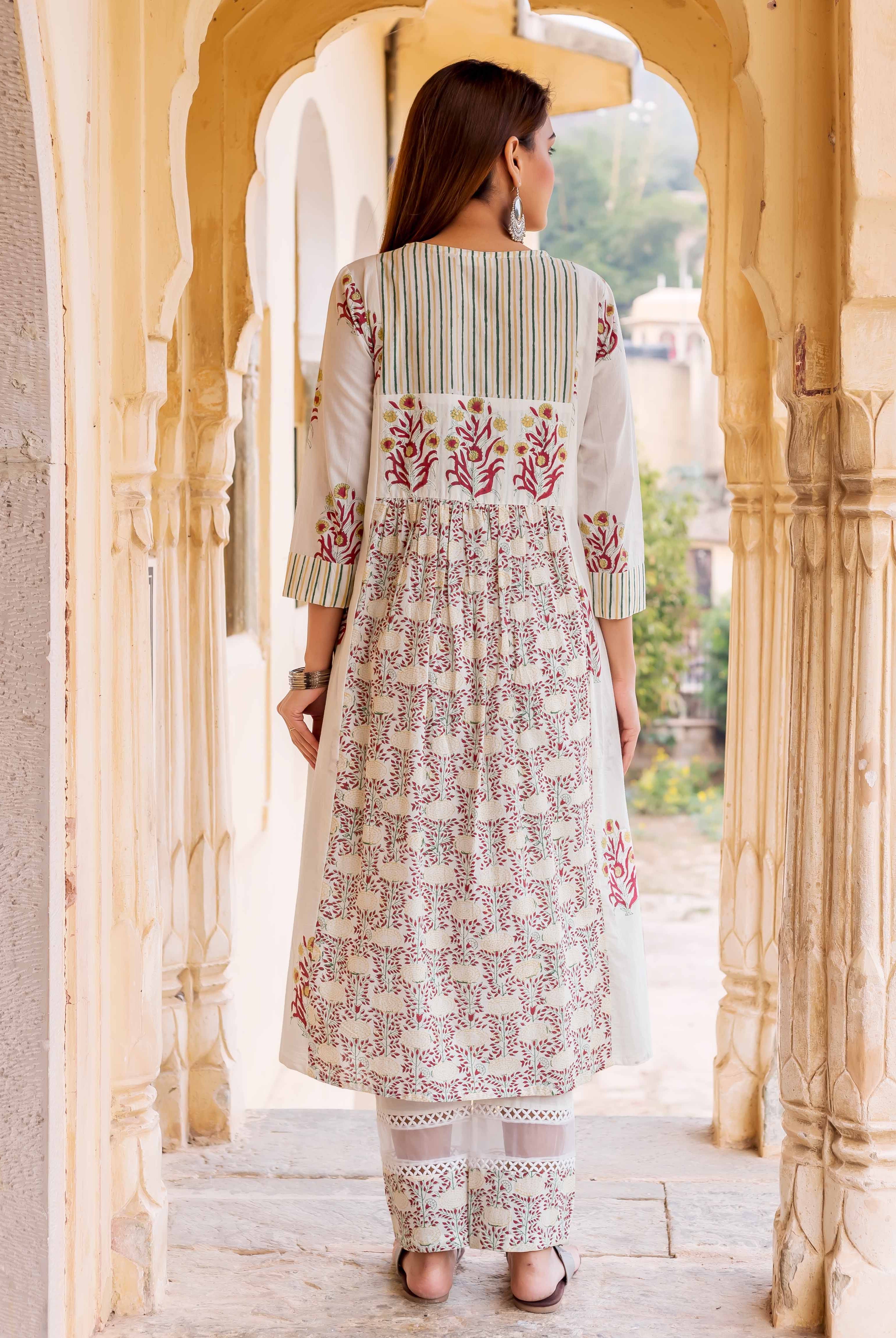 Back view of woman in off-white hand-block printed kurta set with floral and striped patterns.