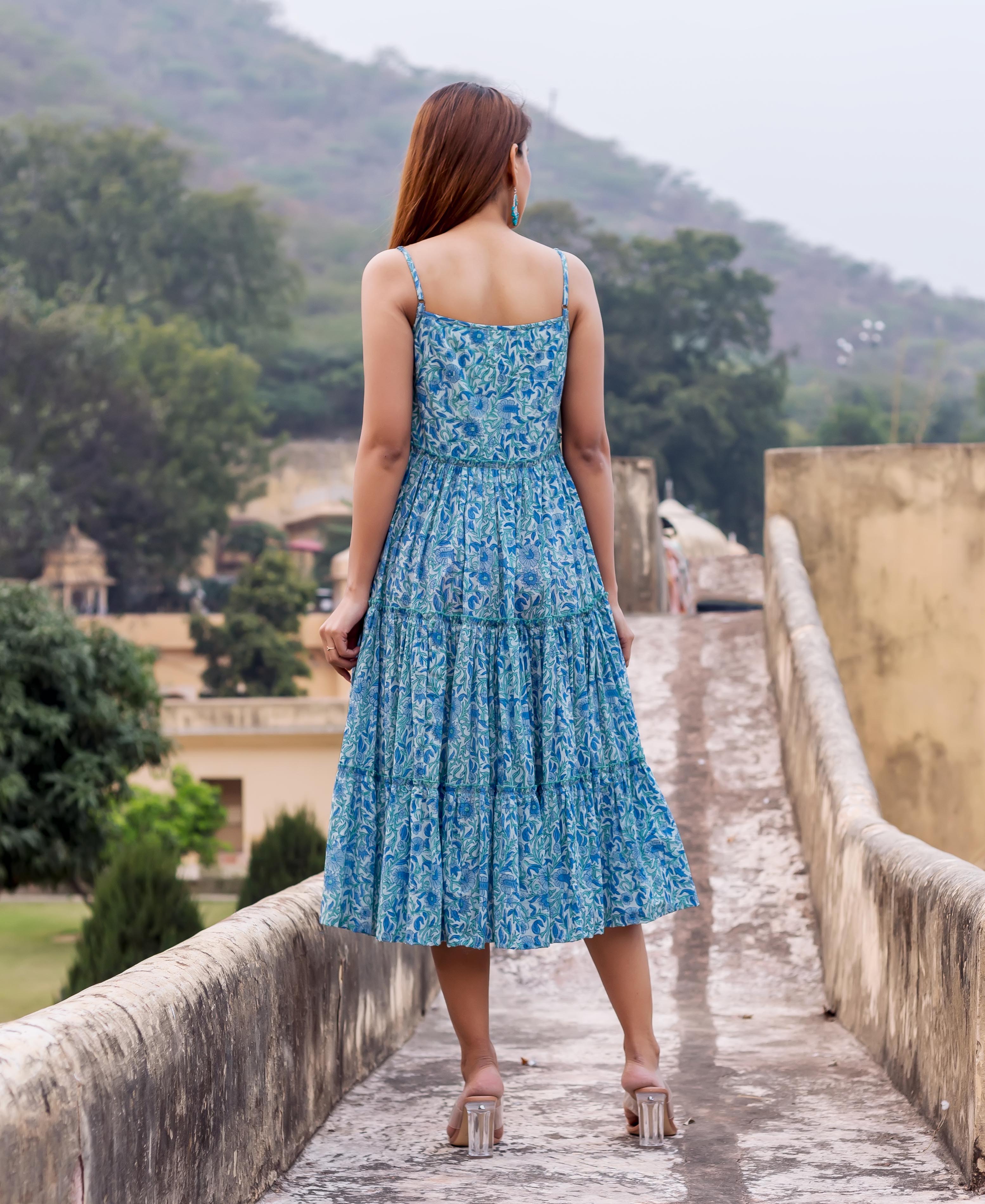 Woman from behind wearing a blue floral hand-block printed tiered sundress.