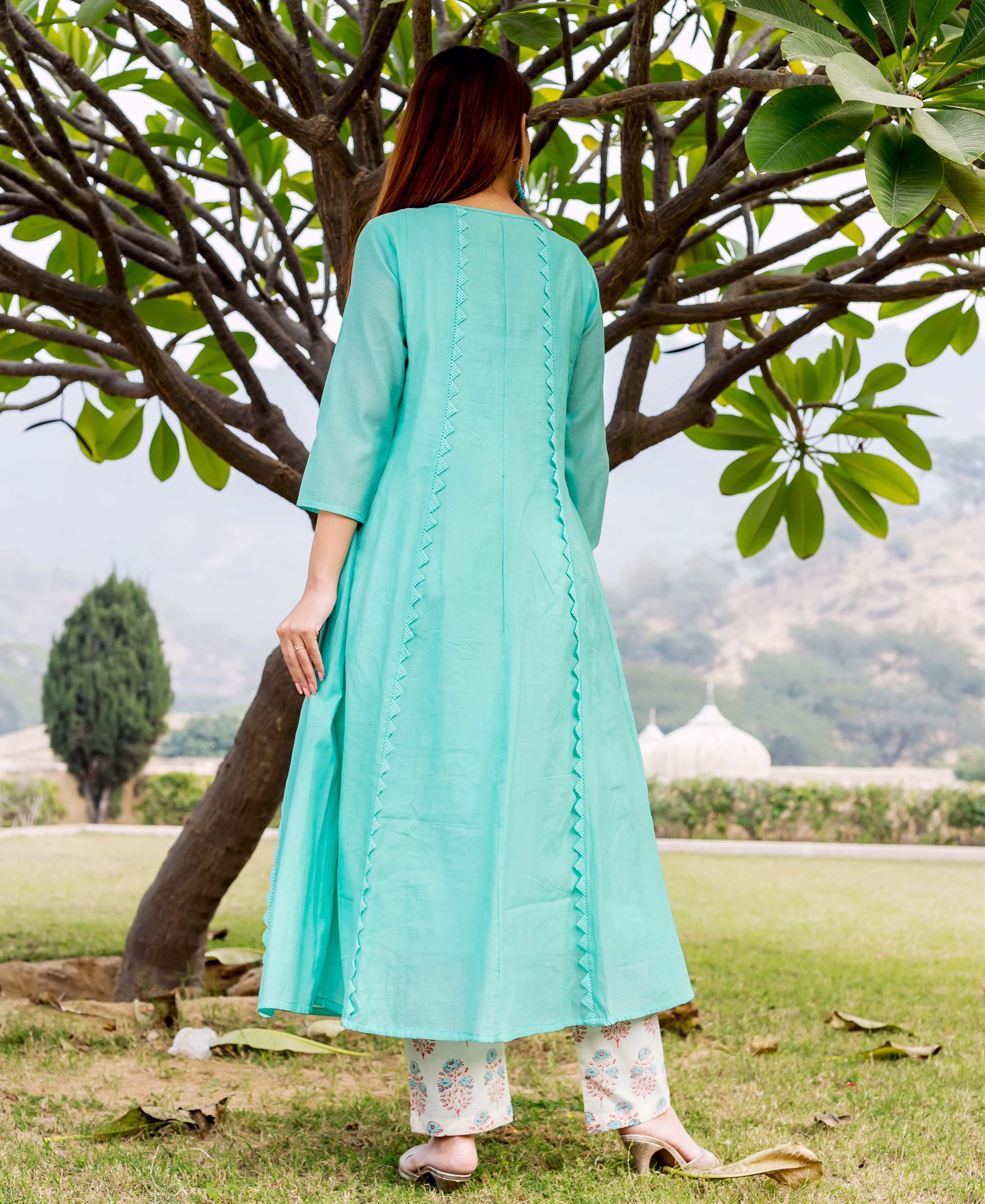 A model wearing a sea green kurta with embroidery and block print.