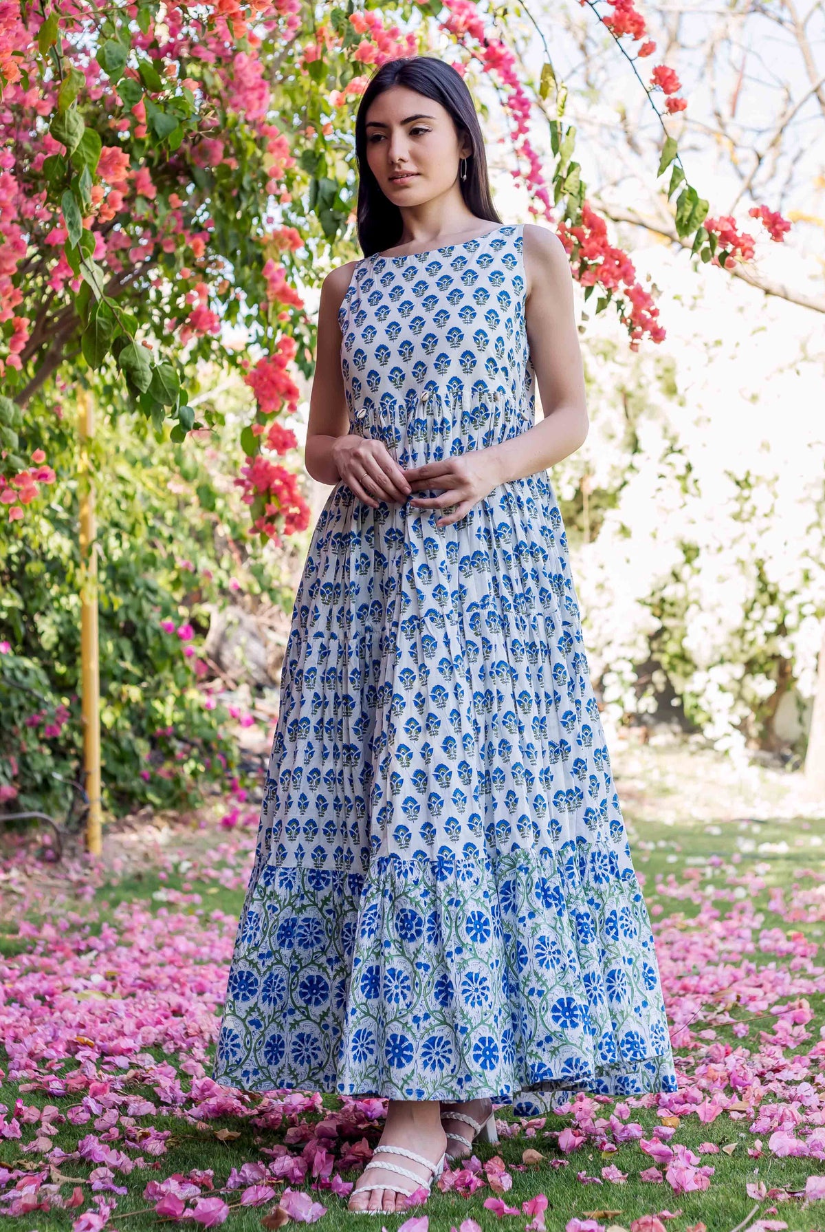 Full-length model wears a white and blue hand-block-printed ethnic tiered maxi dress with floral patterns.