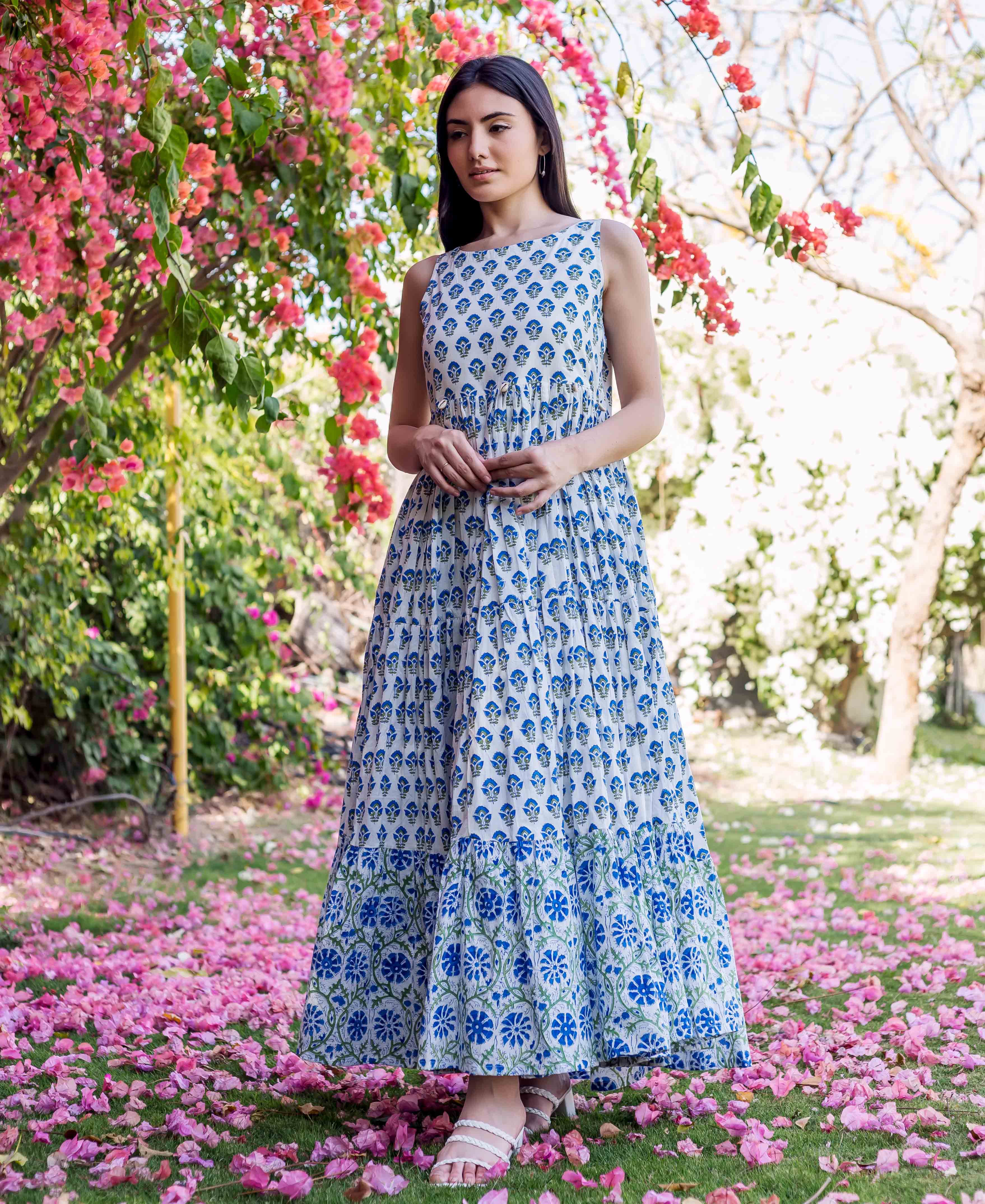 Full-length model wears a white and blue hand-block-printed ethnic tiered maxi dress with floral patterns.