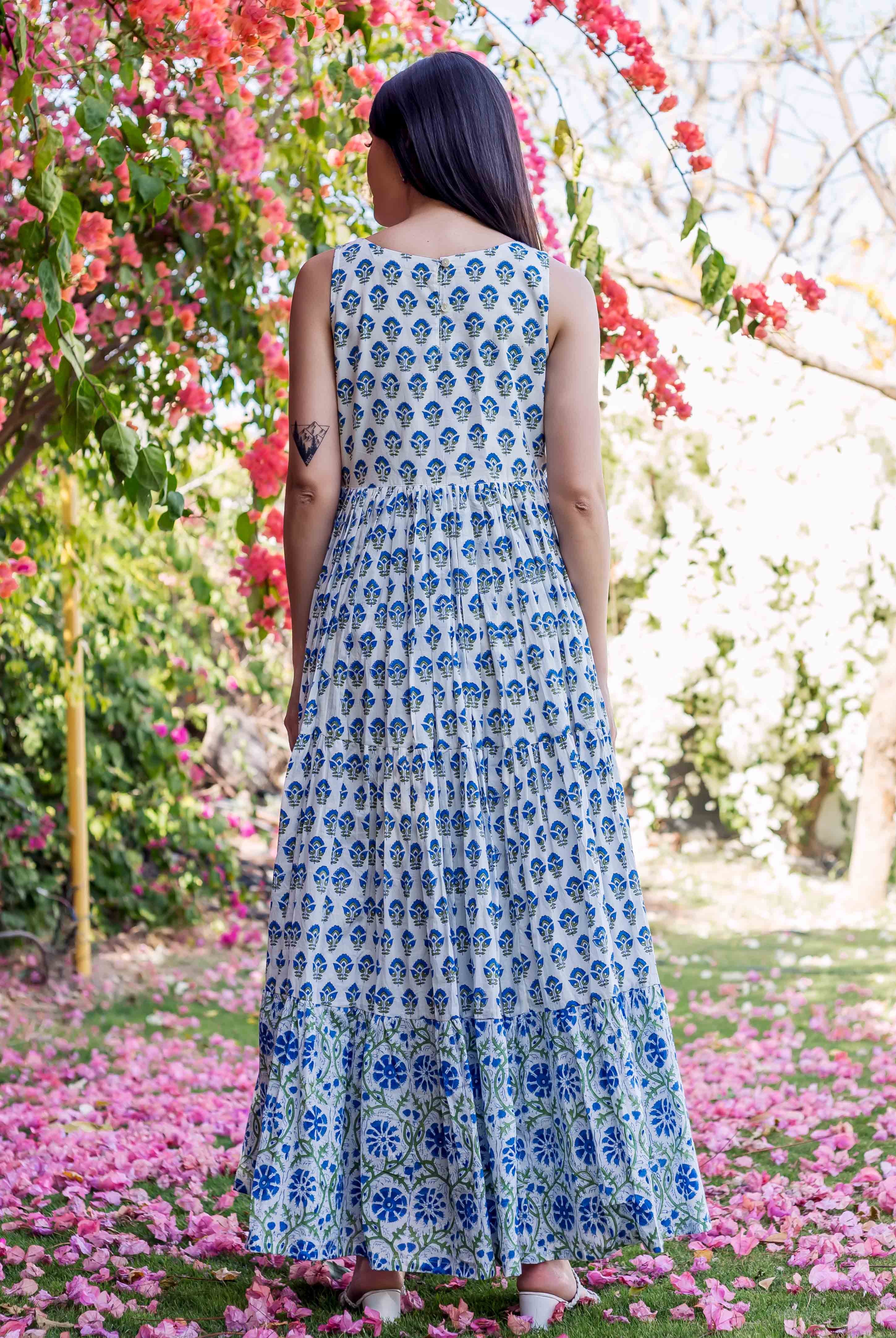 Woman from behind wearing a white and blue tiered hand-block printed ethnic dress.