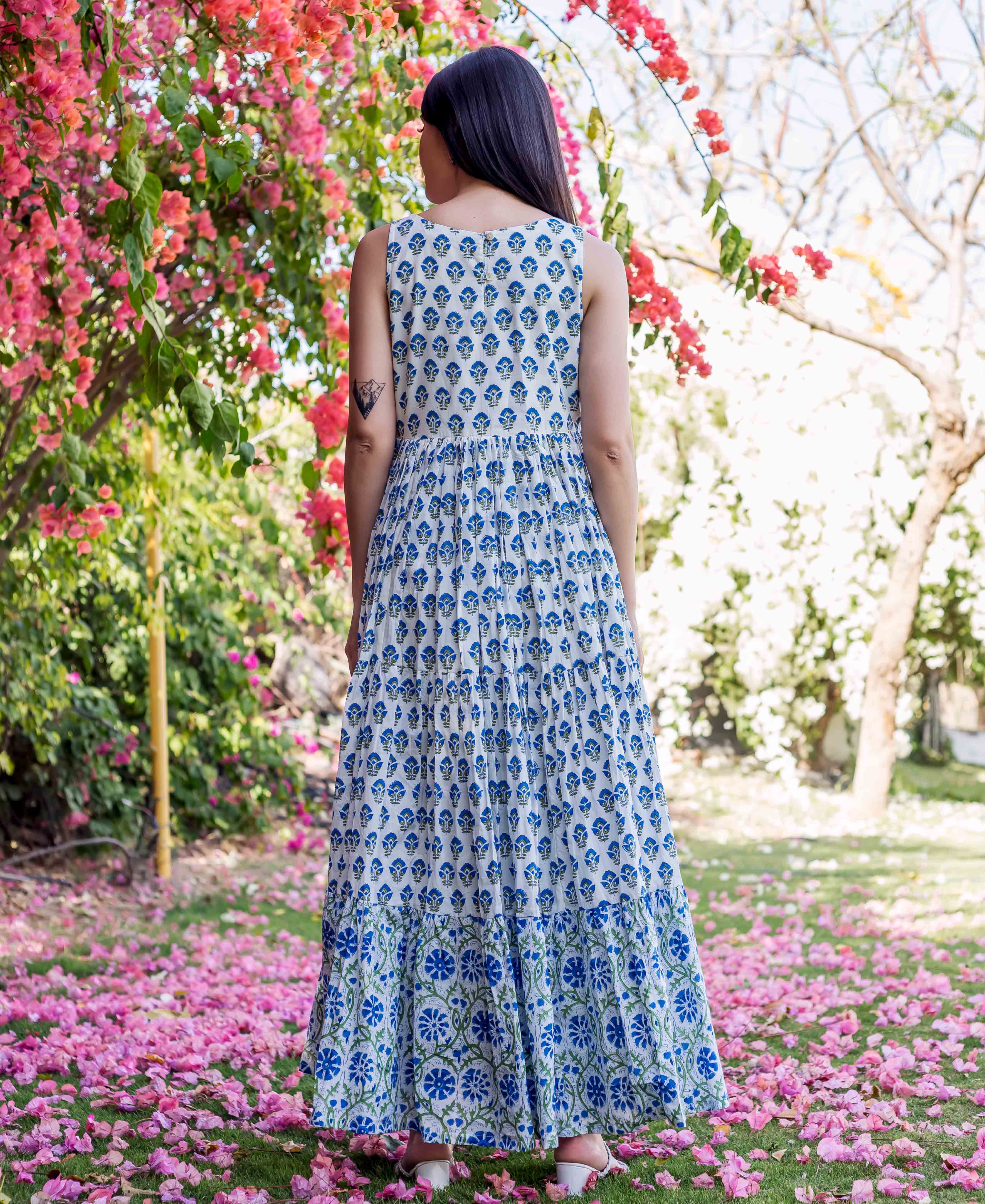 Woman from behind wearing a white and blue tiered hand-block printed ethnic dress.