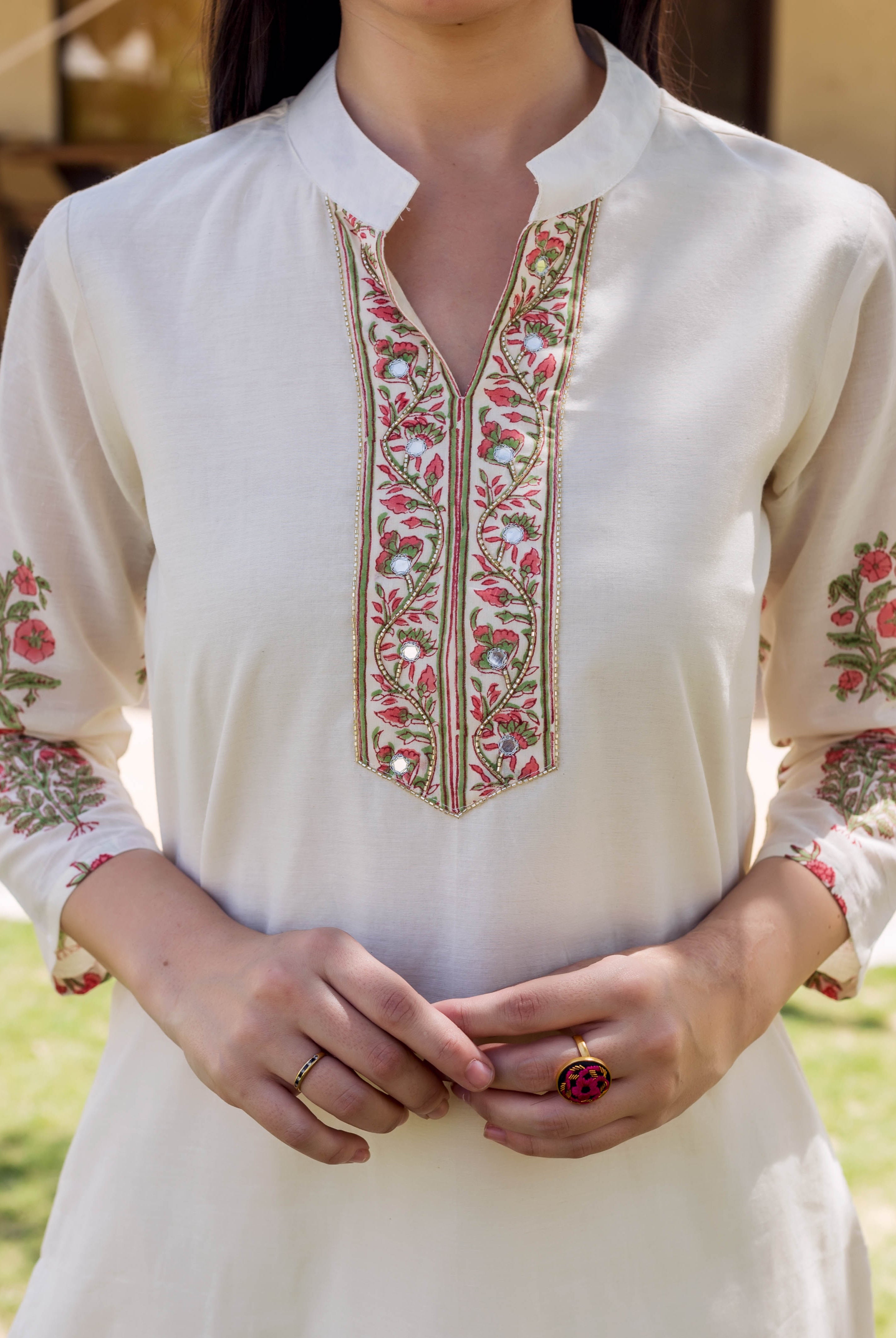 A model wearing an ivory kurta with block-printed and embroidered floral designs.