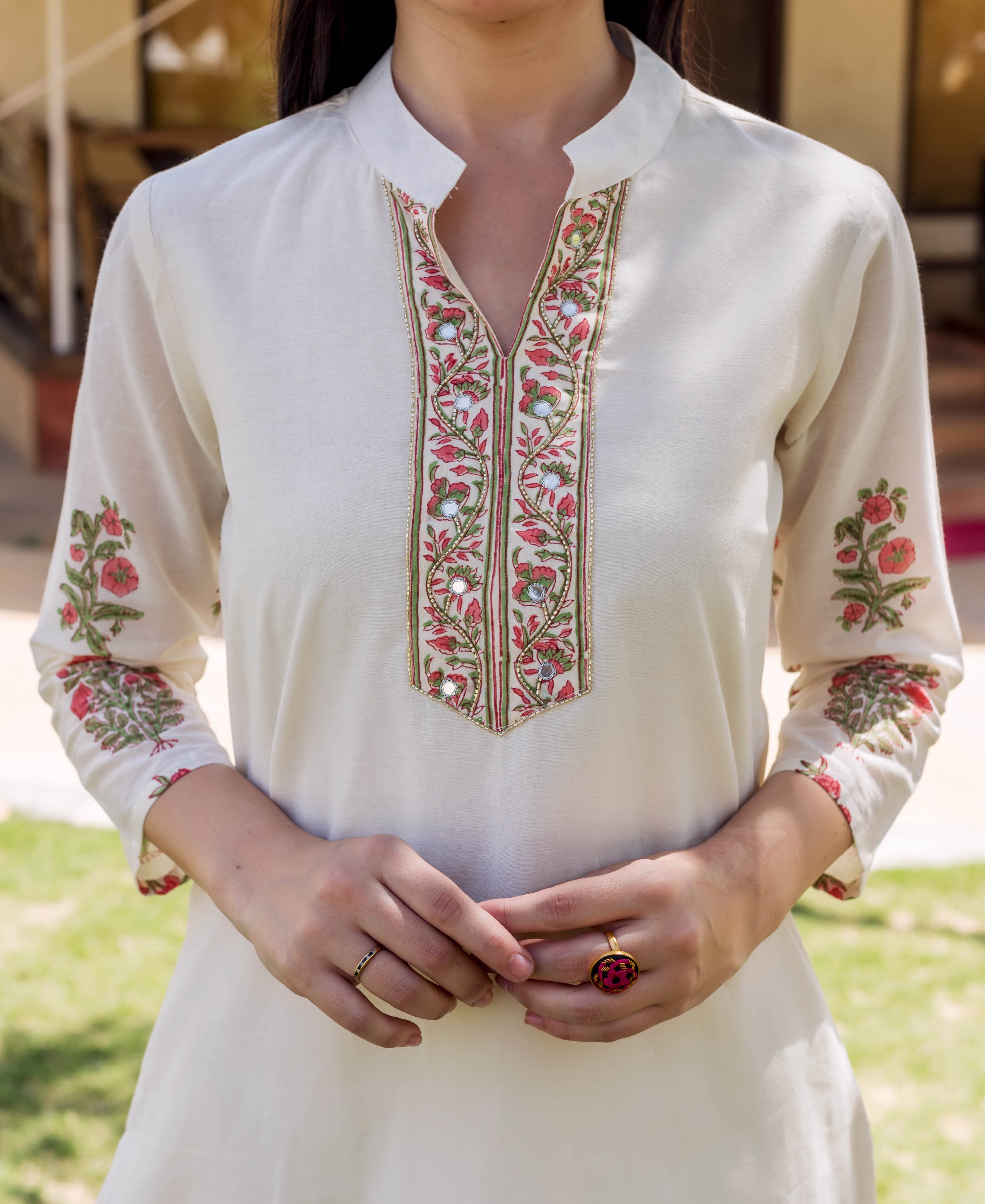A model wearing an ivory kurta with block-printed and embroidered floral designs.