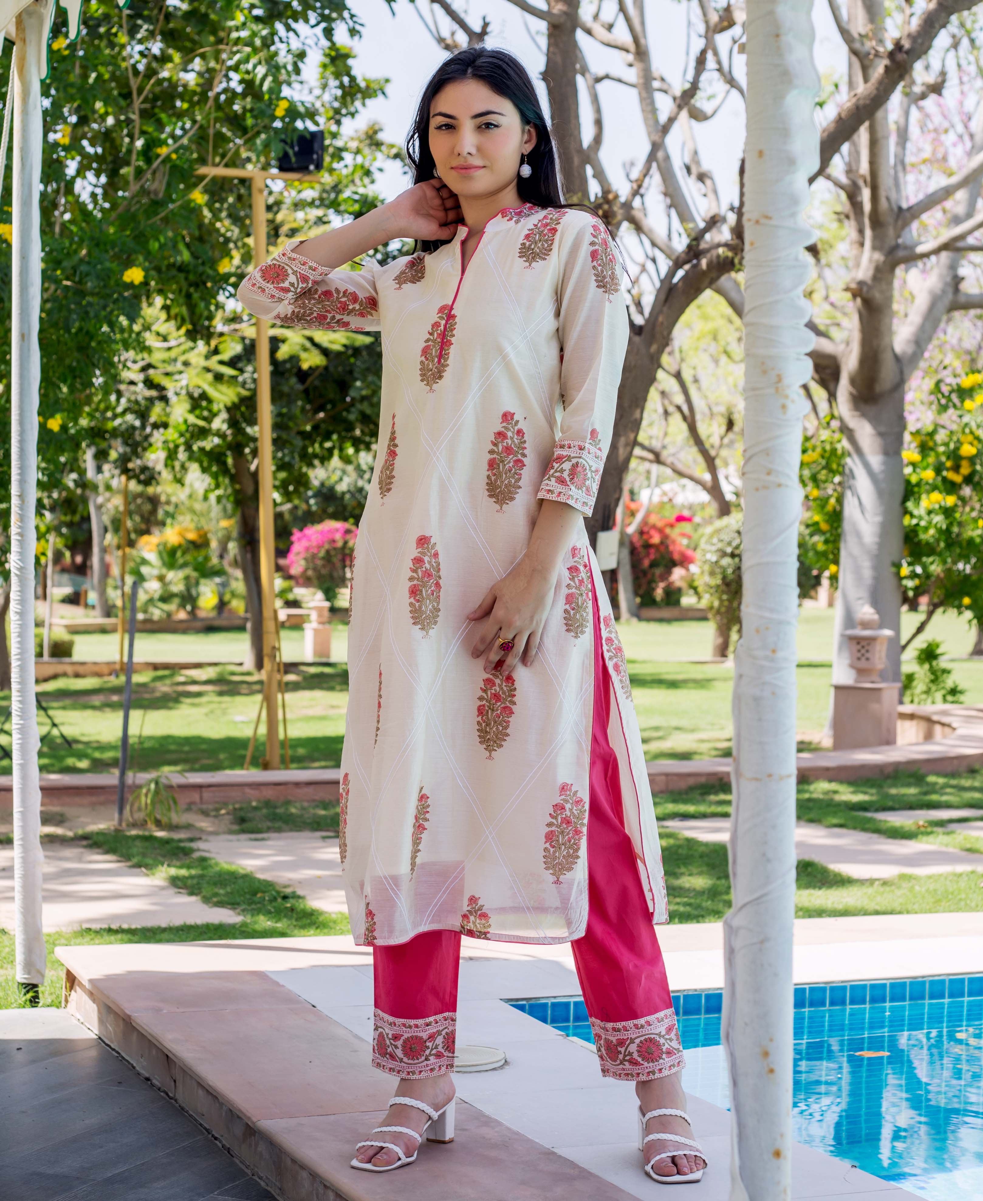 A model wearing a white and pink embroidered and printed straight kurta.