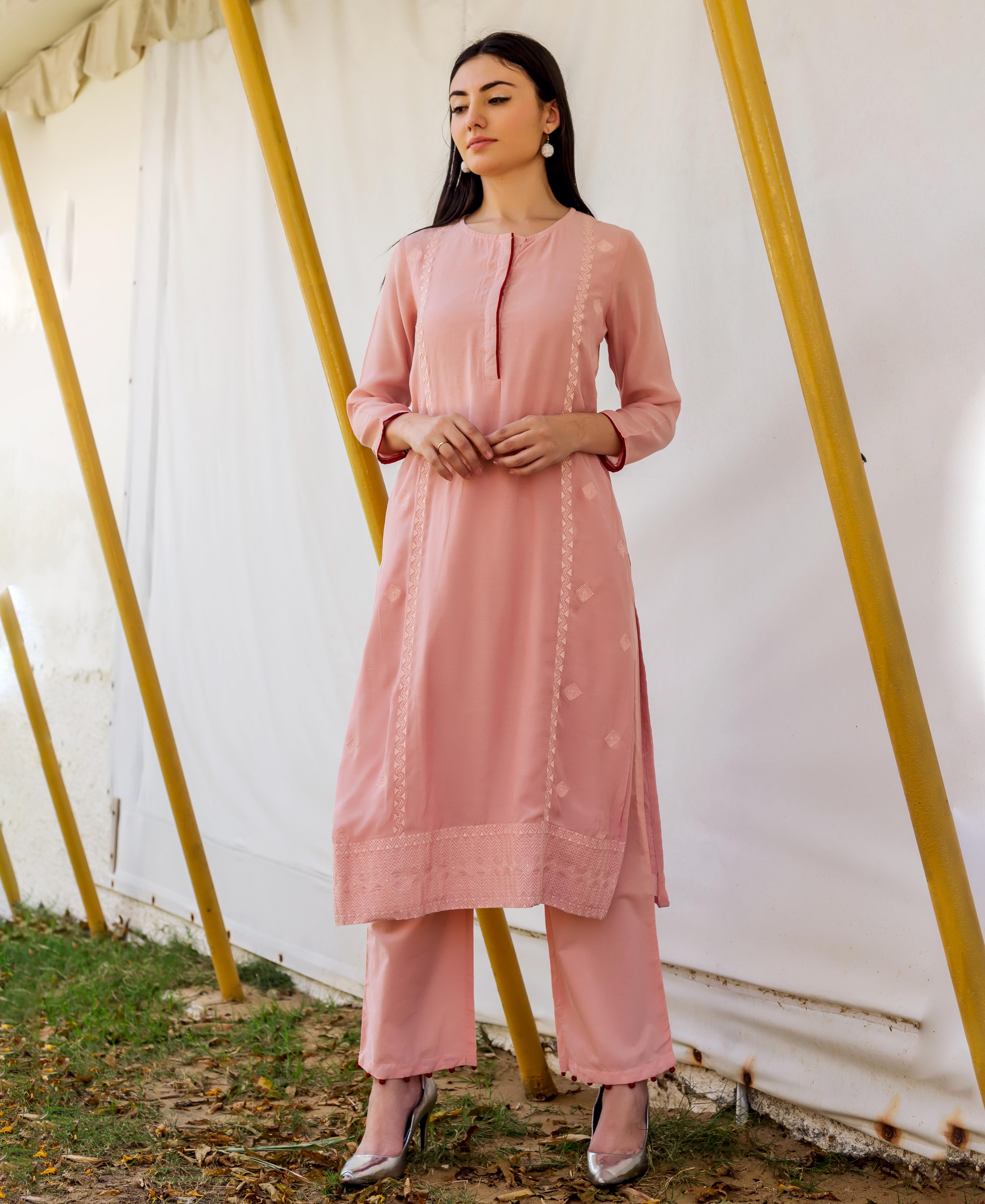 A model wearing a dusty pink embroidered straight kurta with white block print.