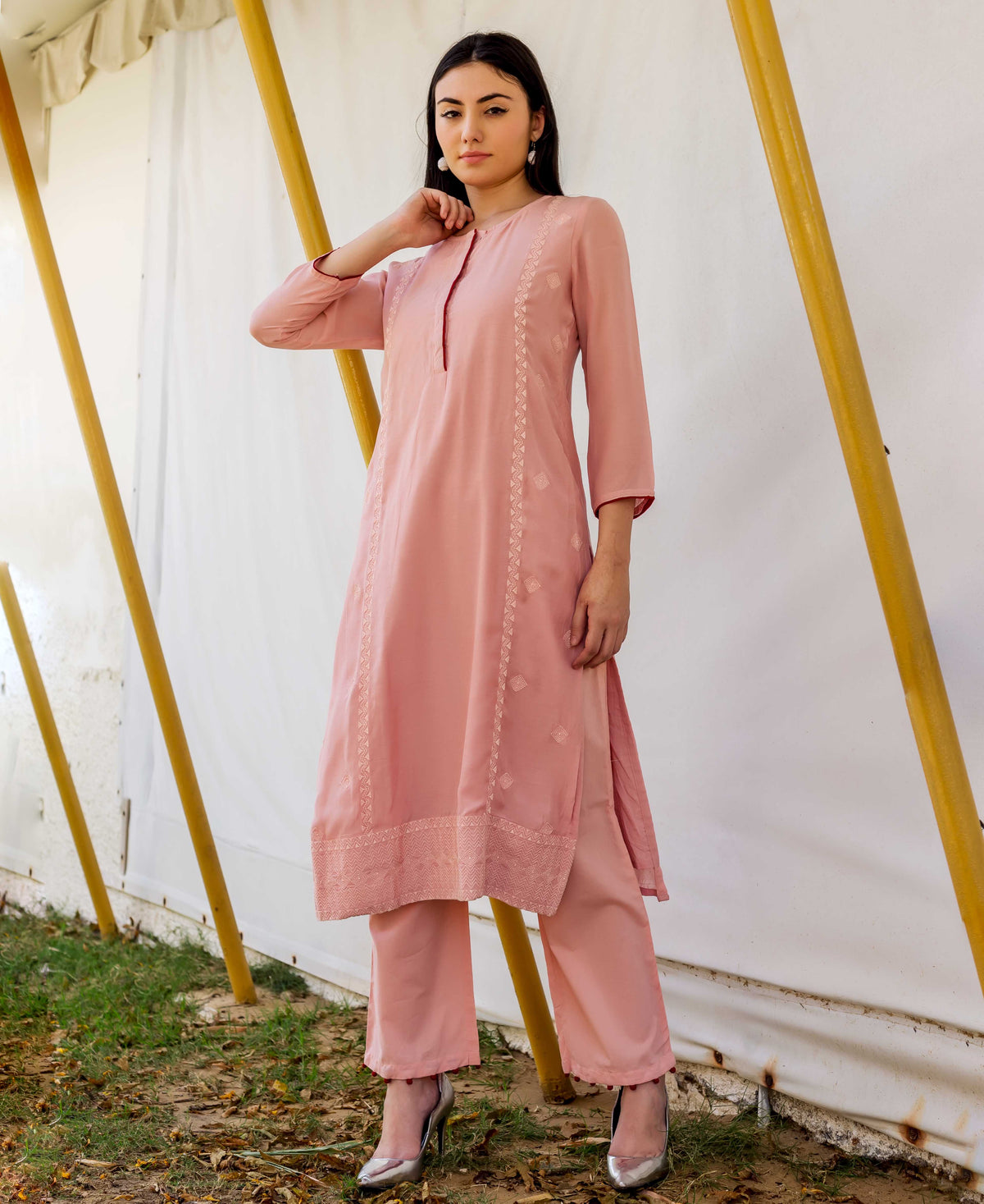 A model wearing a dusty pink embroidered straight kurta with block print.