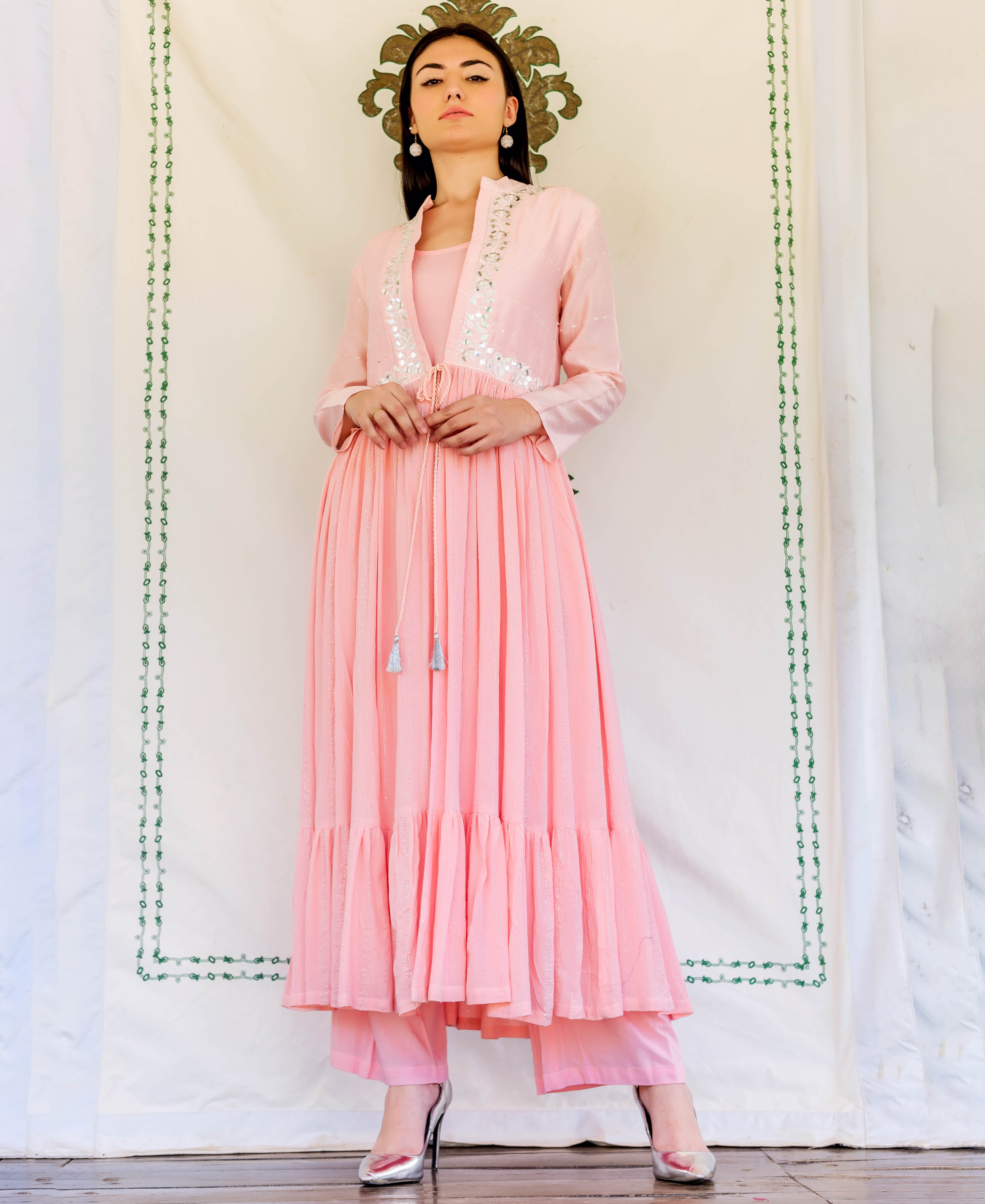 Front full look of model wearing Flamingo Pink layered kurta with mirror work.