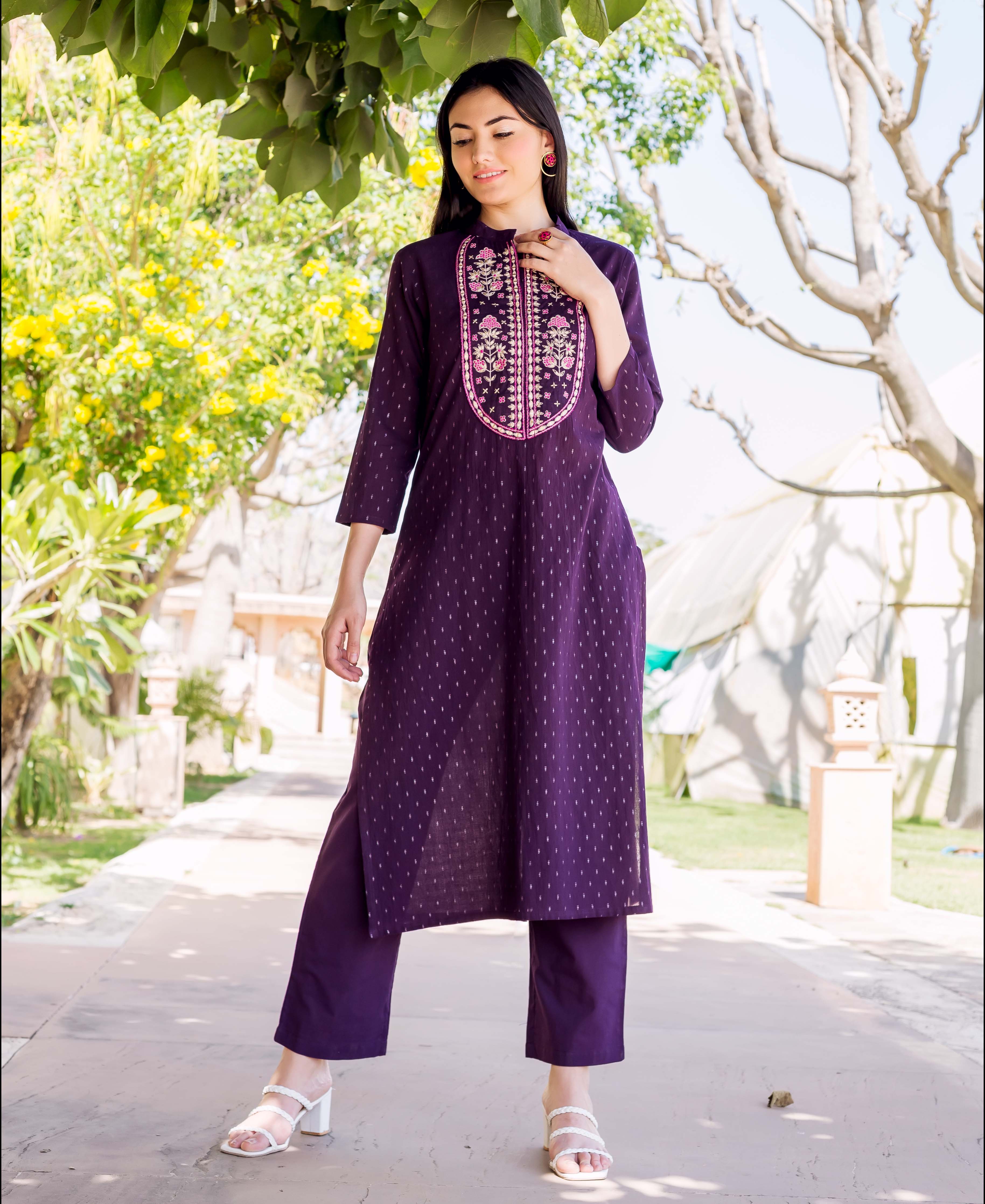 Model in deep wine straight kurta with subtle lurex pattern and pink floral embroidered yoke.