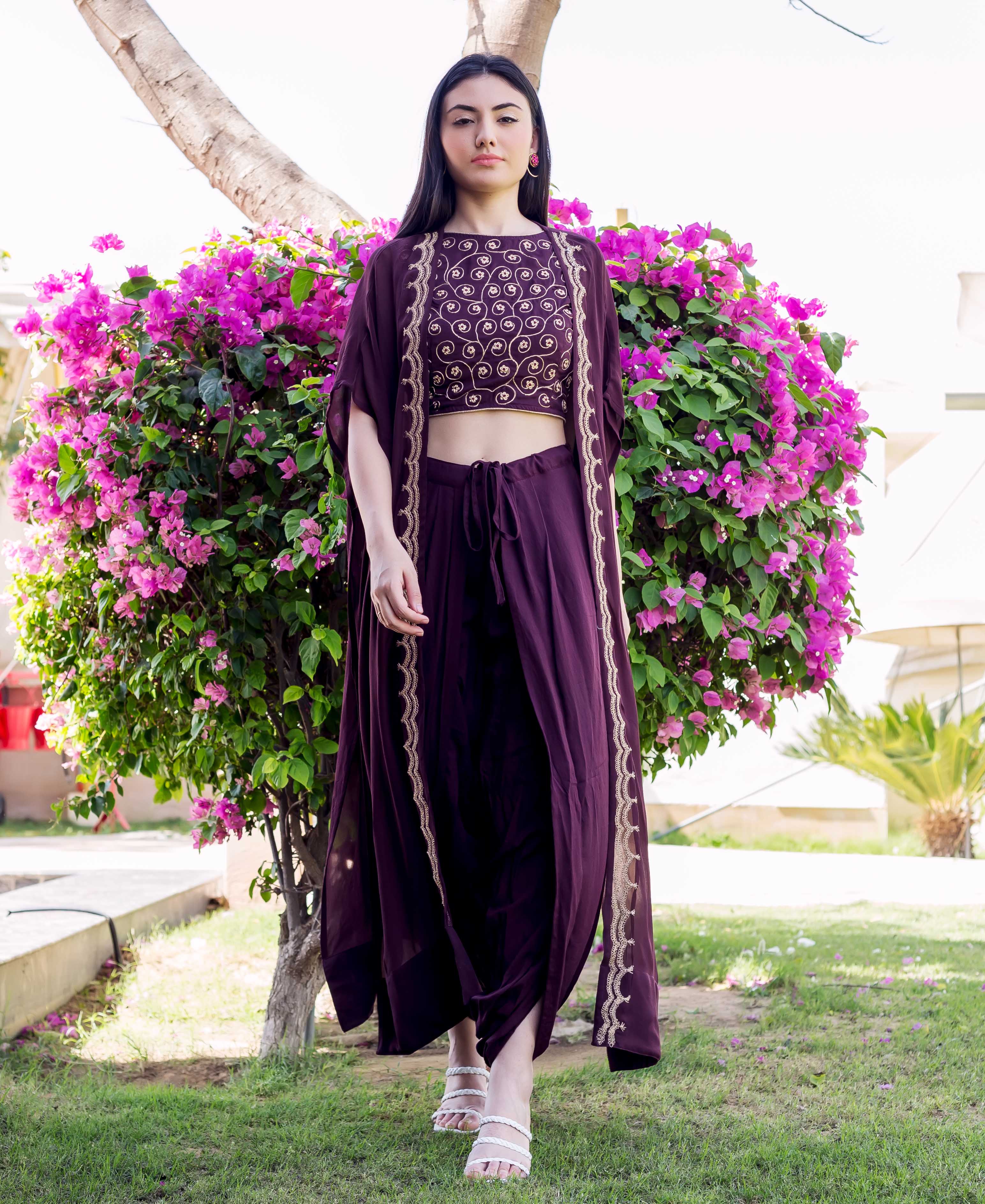 Full-body shot of a model wearing a wine dori embroidered dhoti and jacket set.