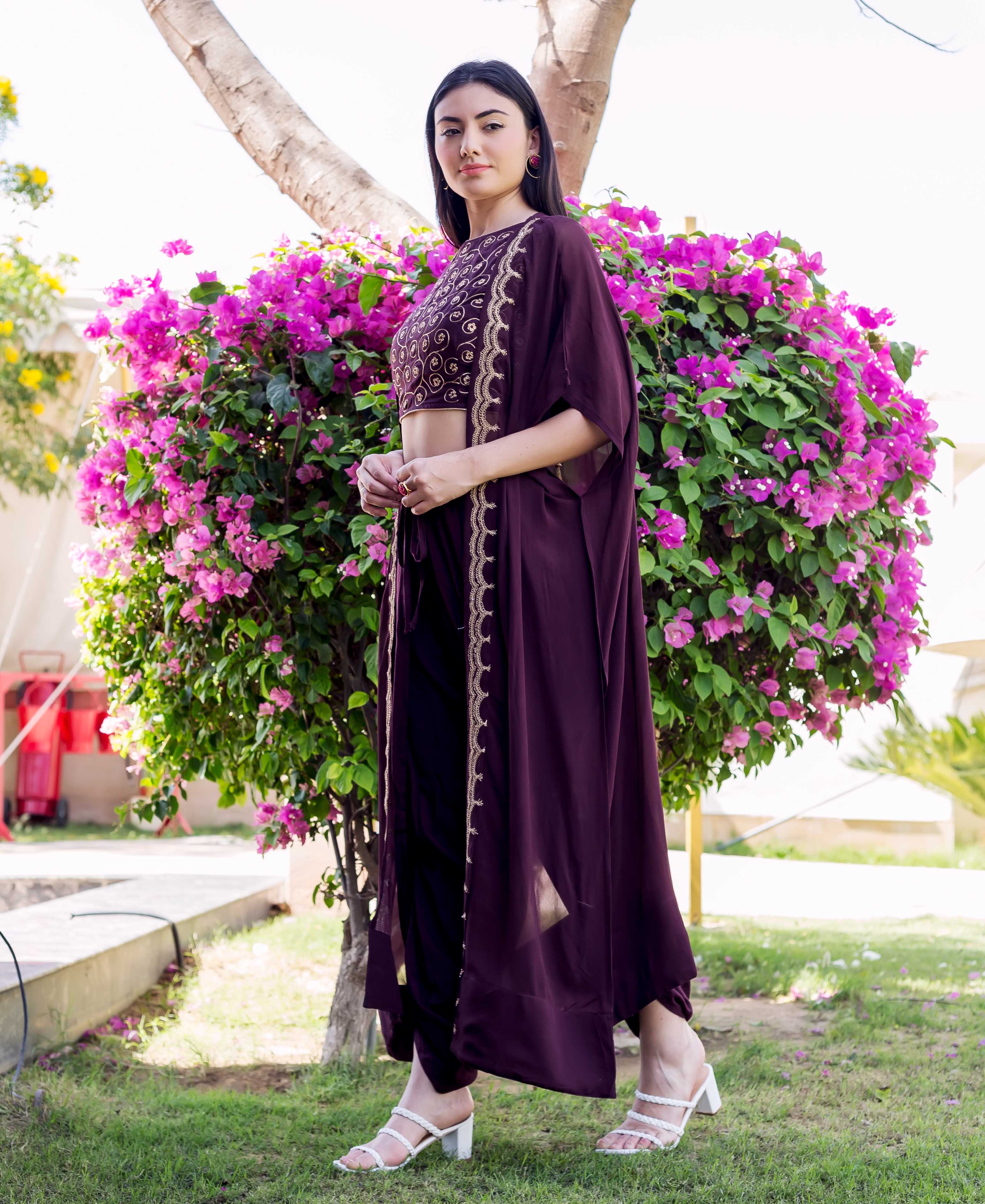 Woman models a wine dori embroidered dhoti and long jacket set.