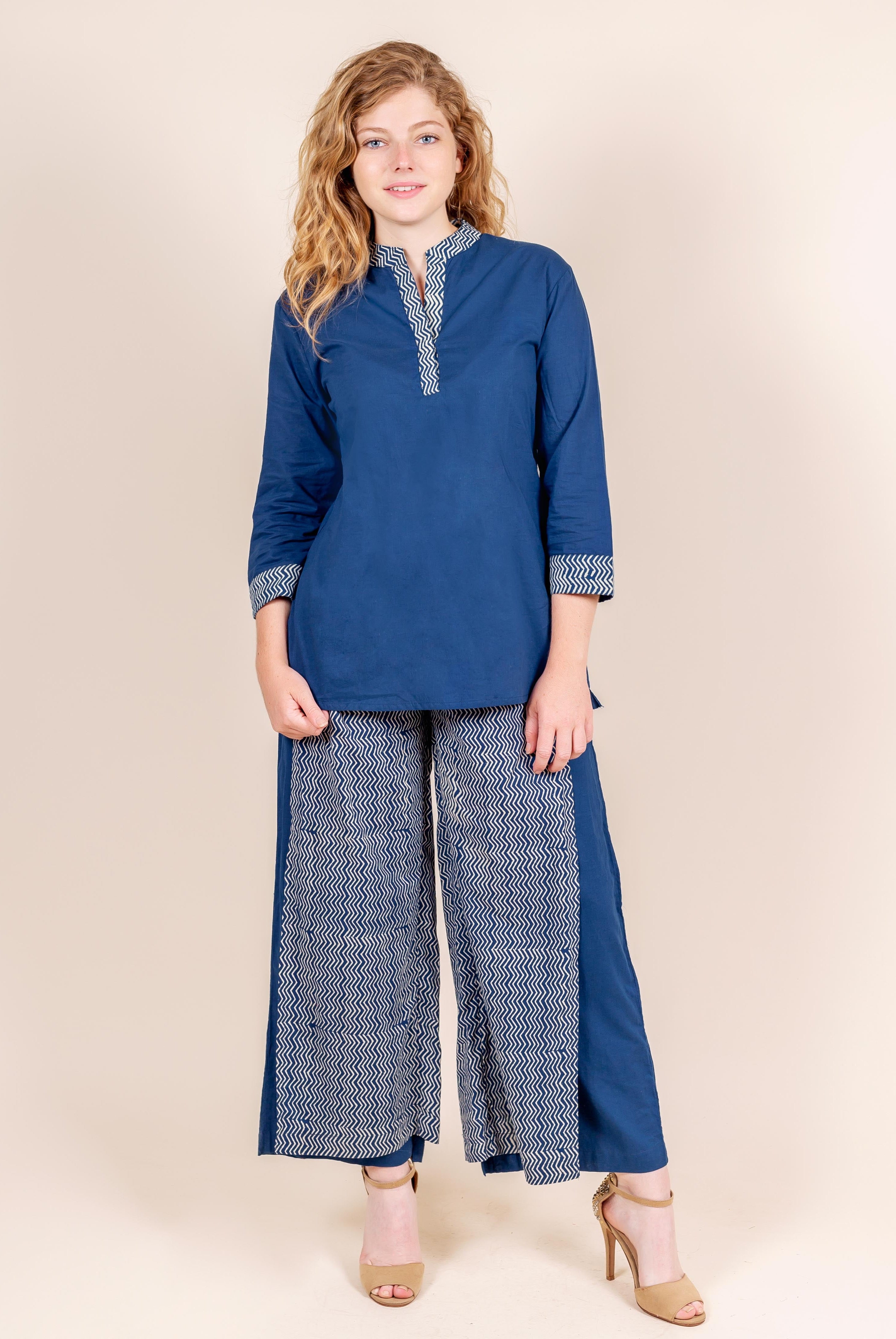 Model wearing indigo blue kurti and palazzos featuring white zigzag hand block print.