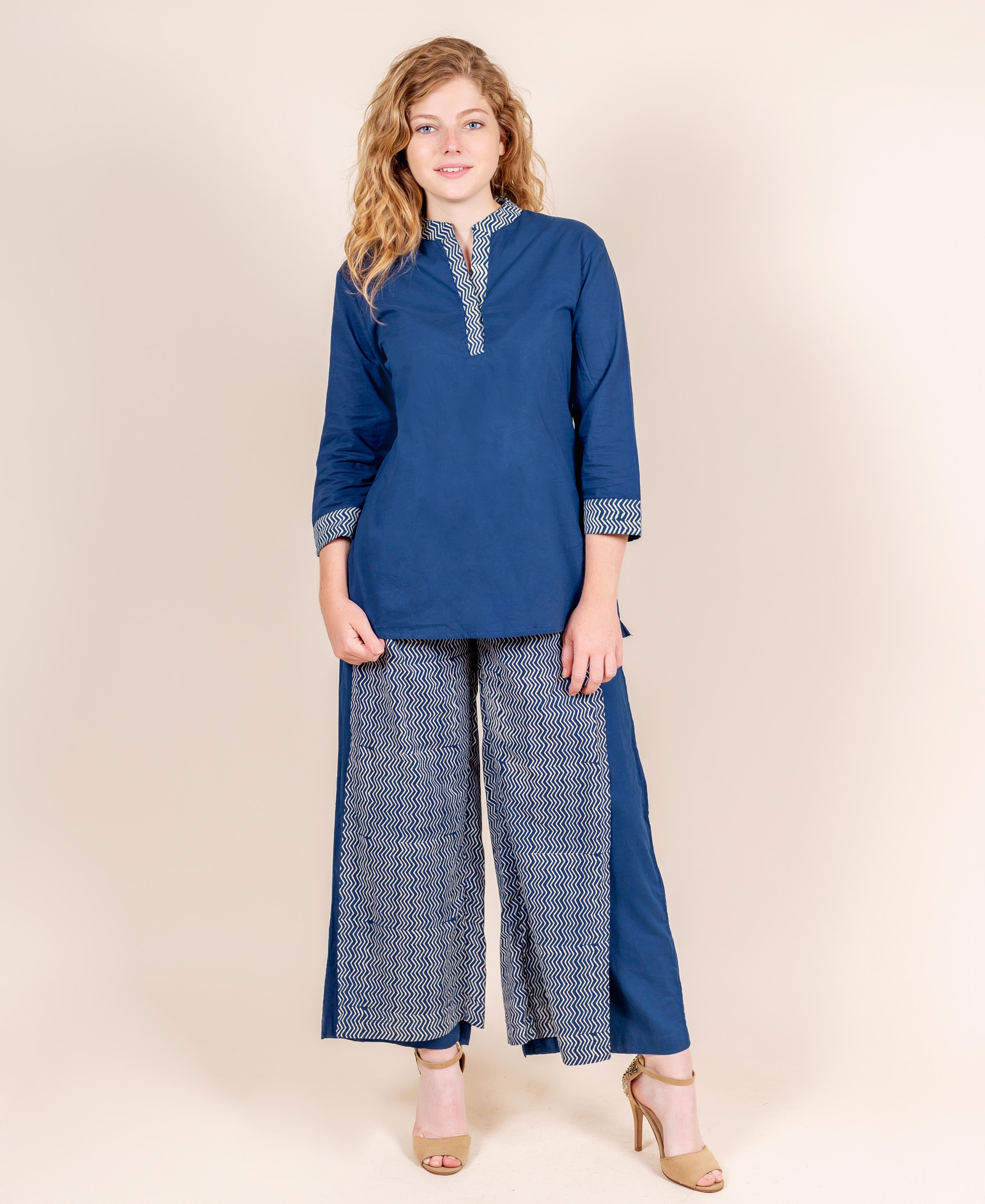 Model wearing indigo blue kurti and palazzos featuring white zigzag hand block print.